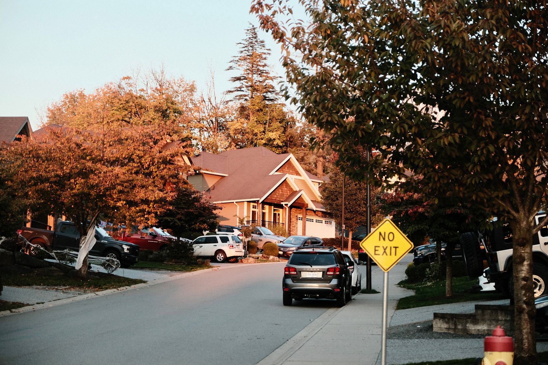 A car parked on a residential street in autumn