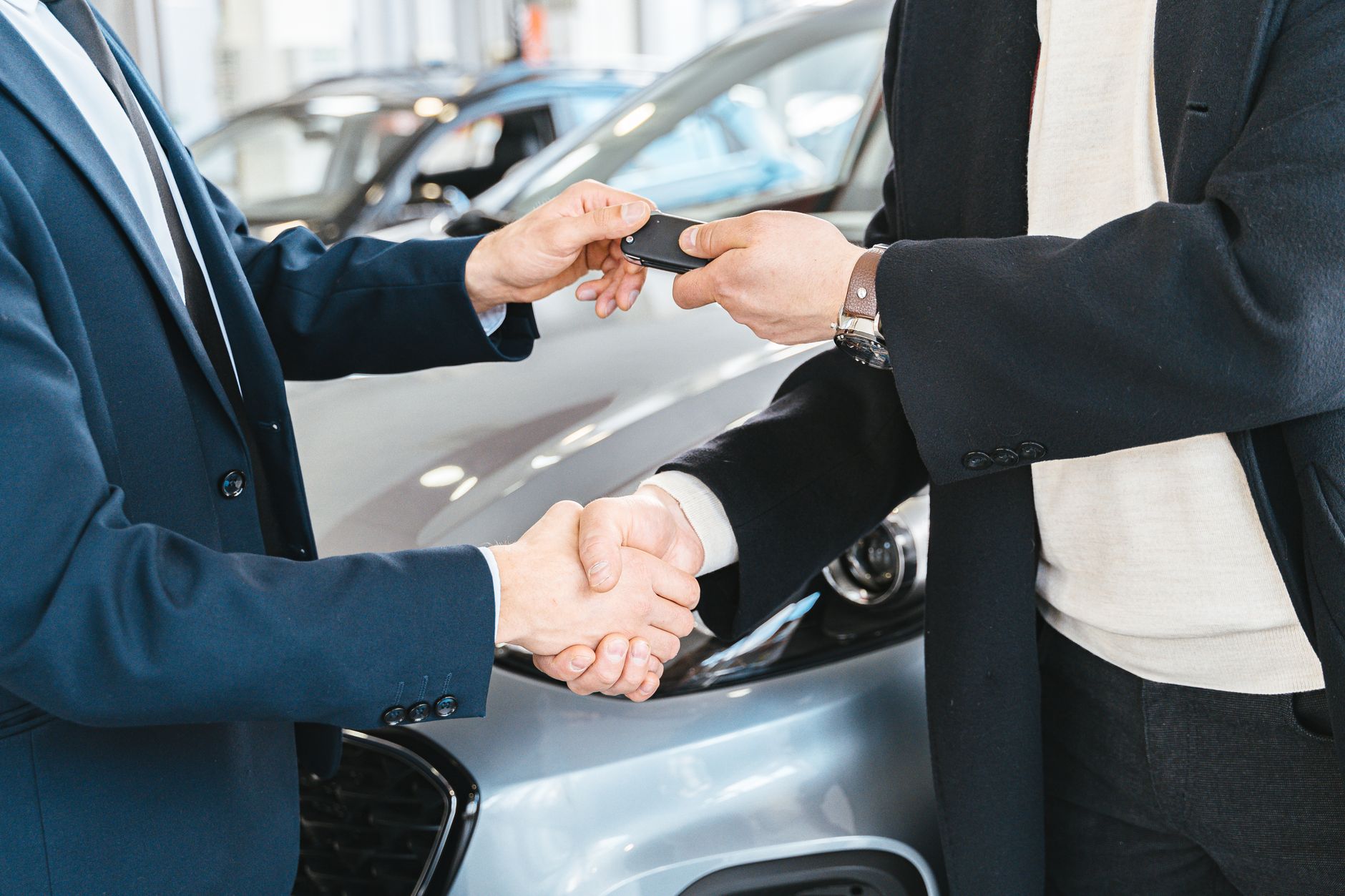 Car keys handed over with a handshake