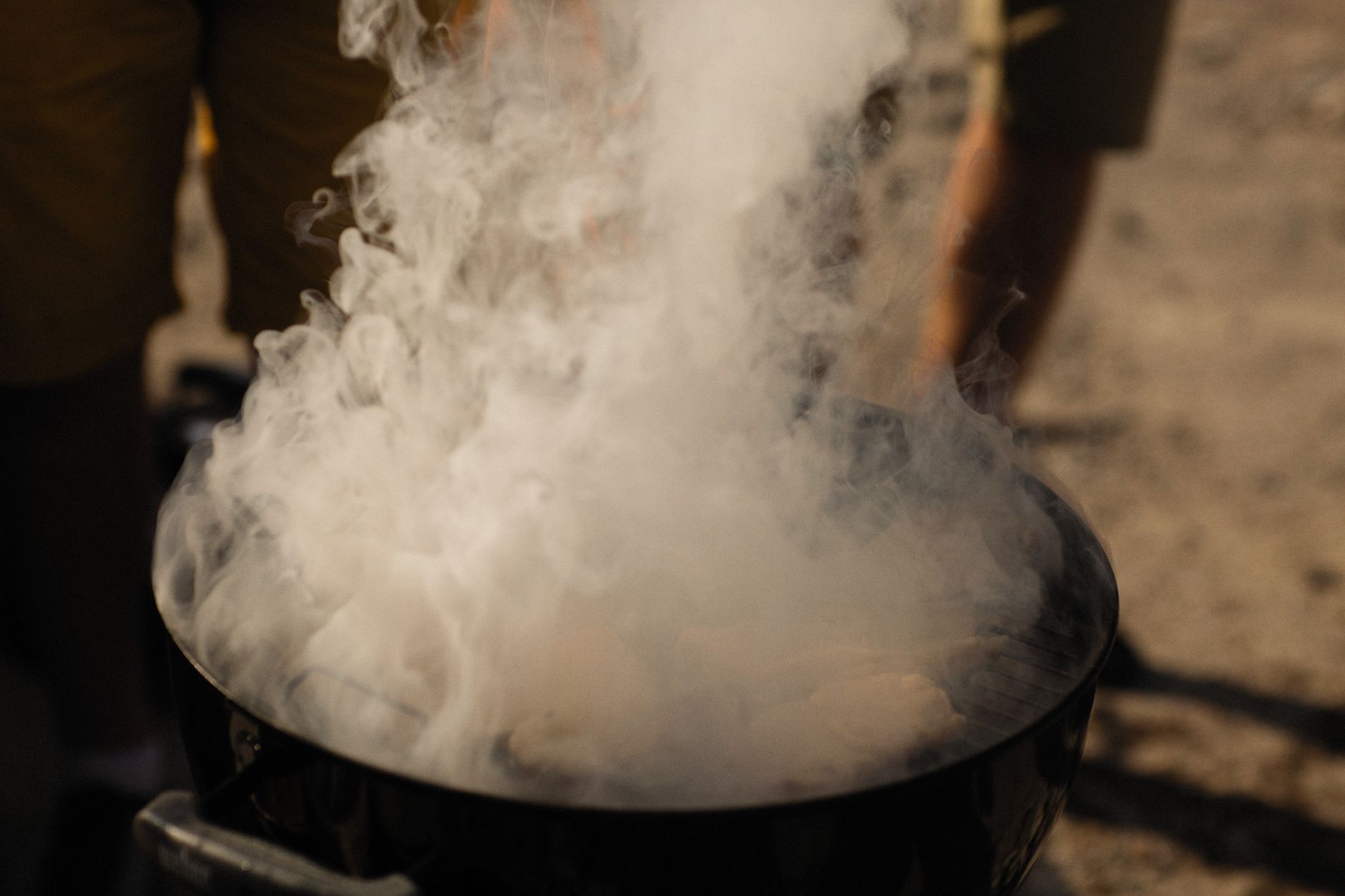 Steam rising from a pot over a fire