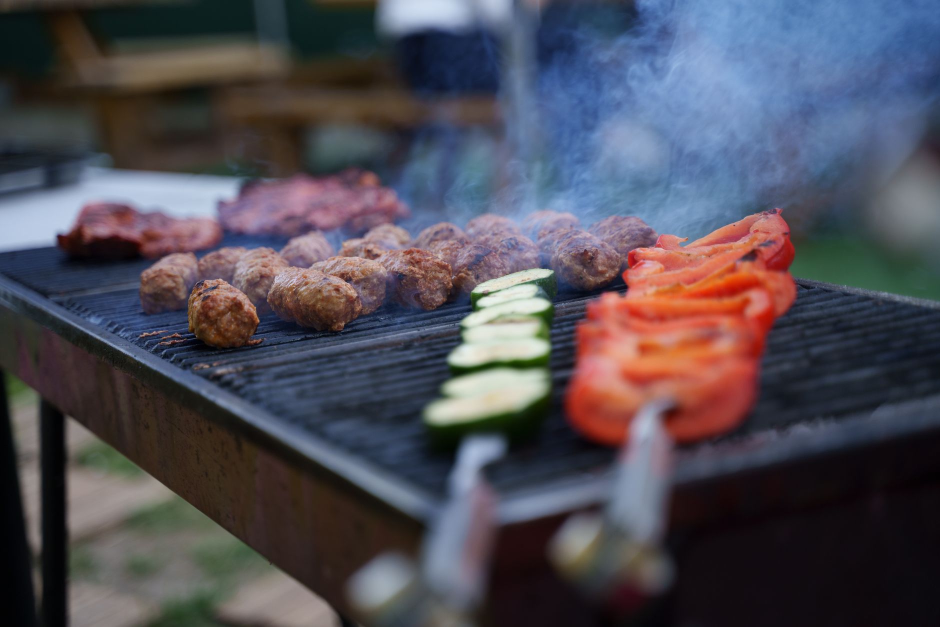 Meat and vegetables on an outdoor grill