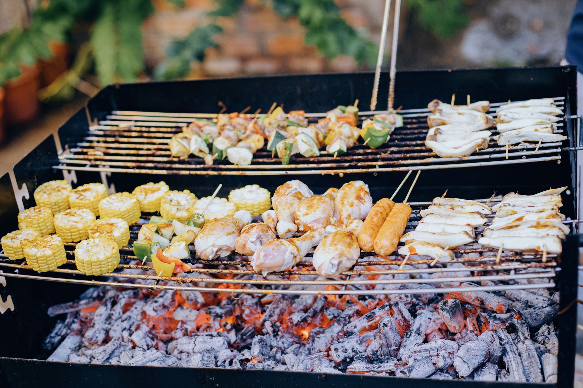 Best grill brush: skewers and corn on a charcoal grill