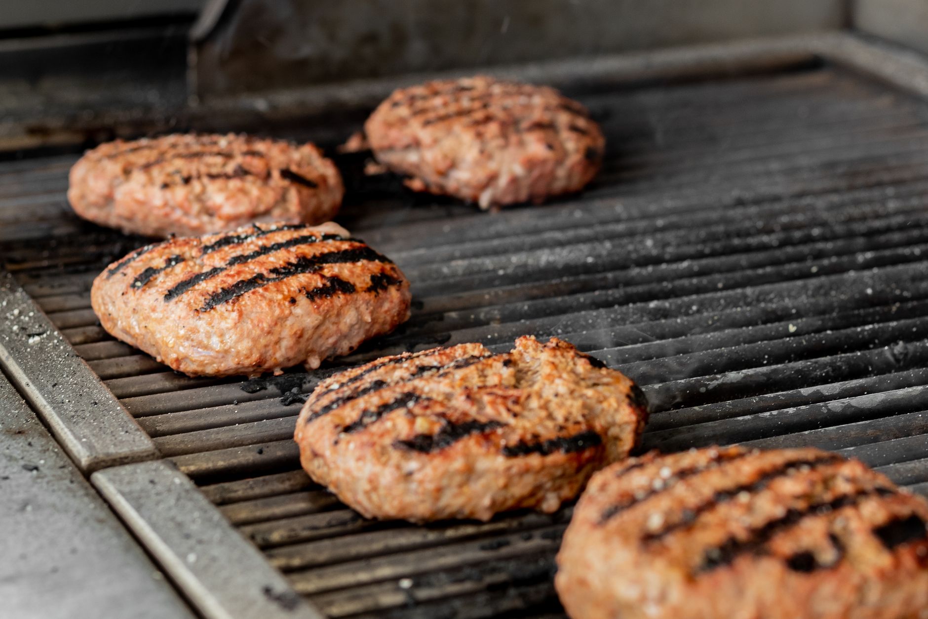 Burgers cooking on a grill