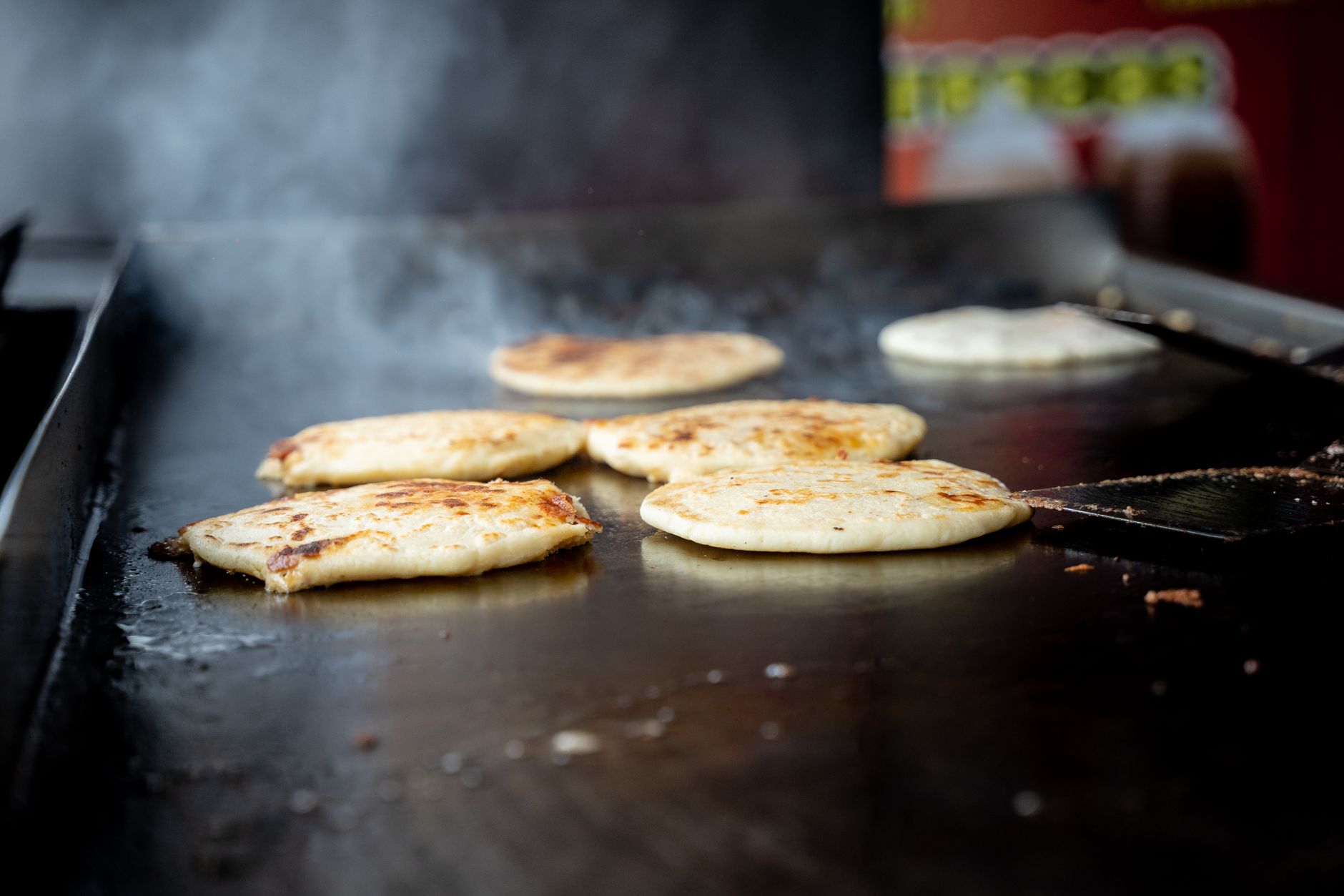 Flatbreads cooking on a flat-top griddle