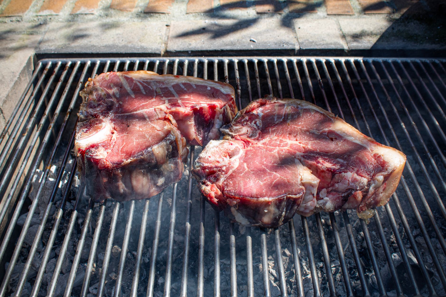 Steaks on a grill grate