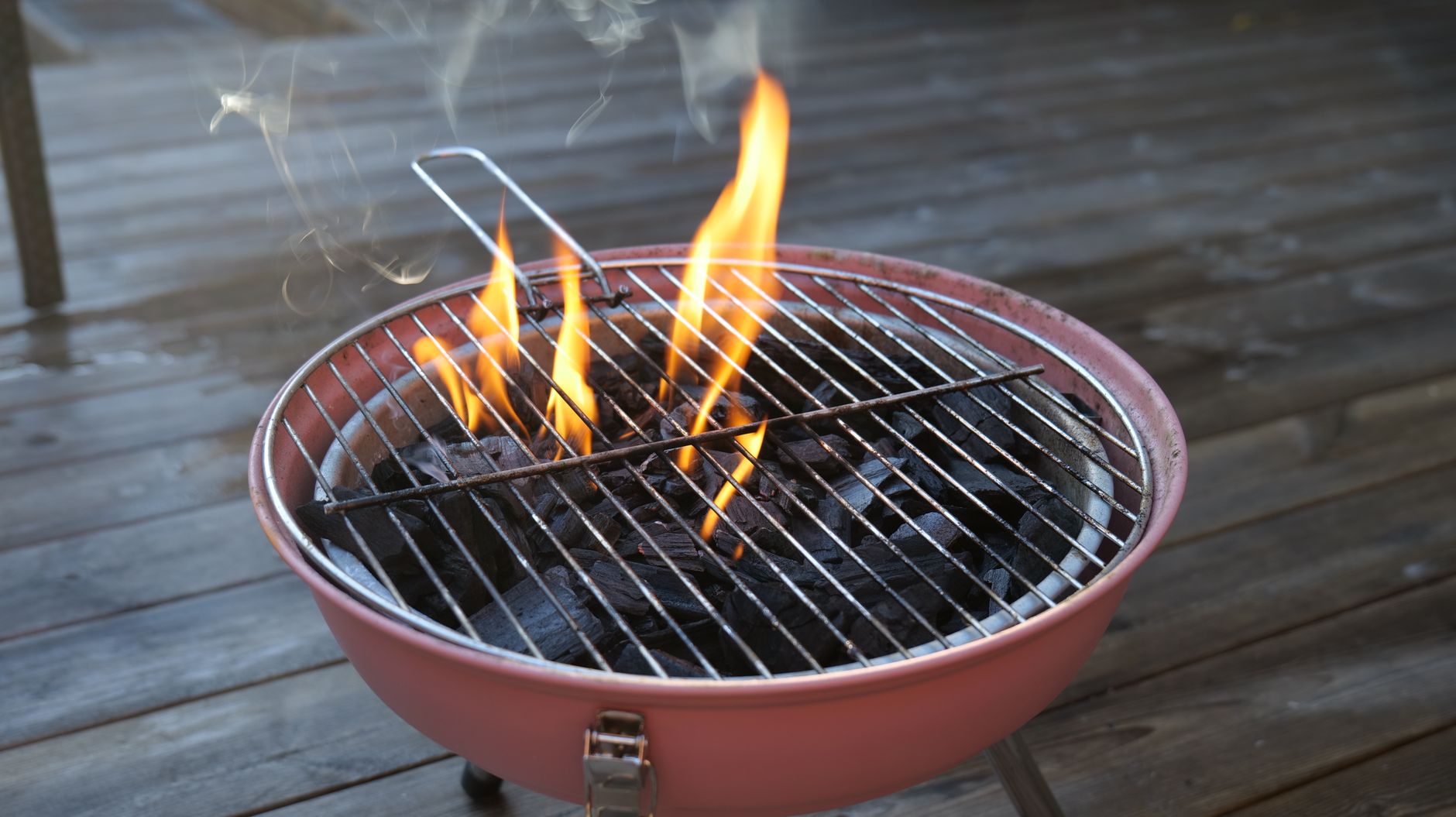 A small charcoal grill with flames