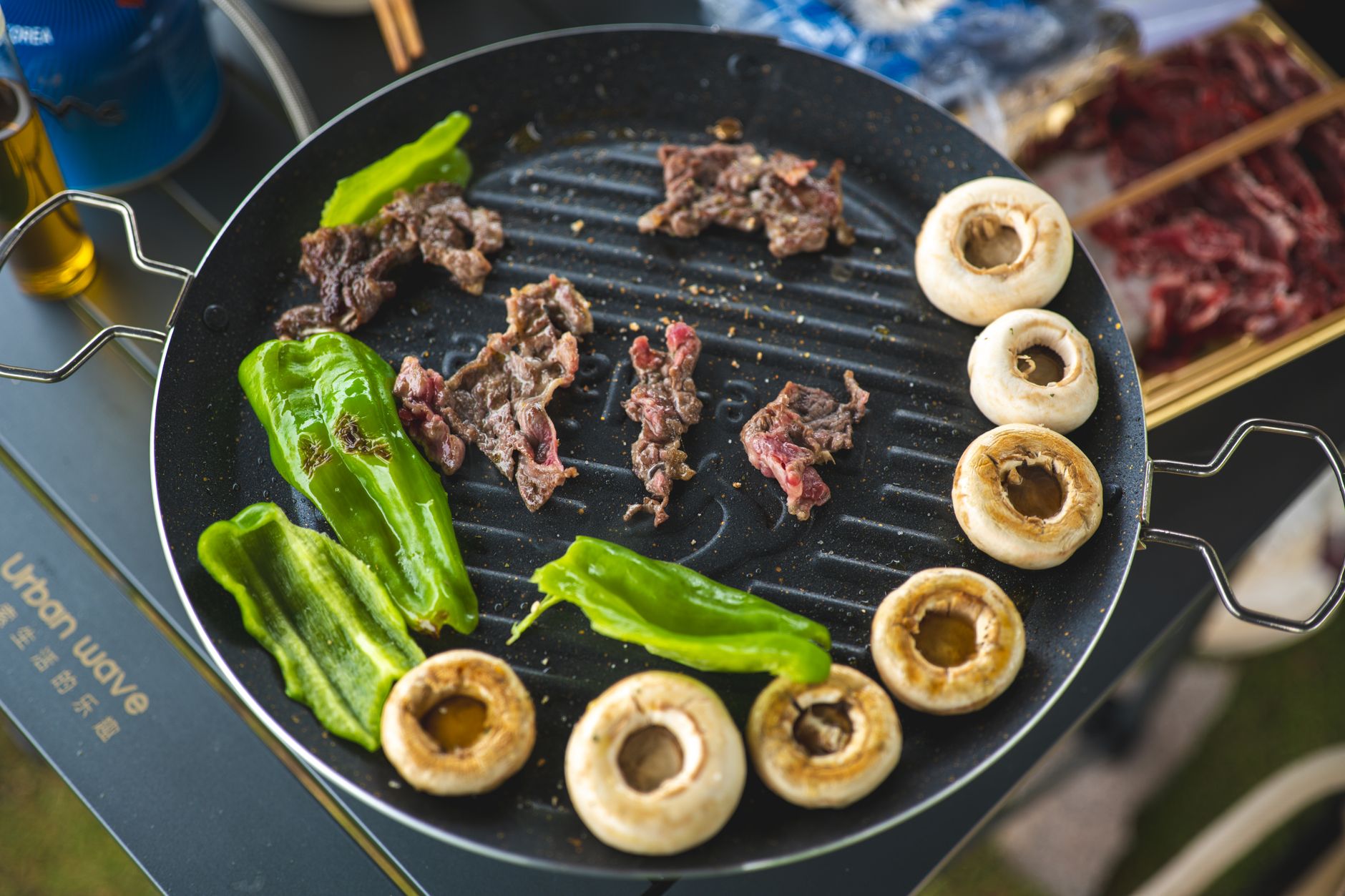 Meat and vegetables on a round grill pan