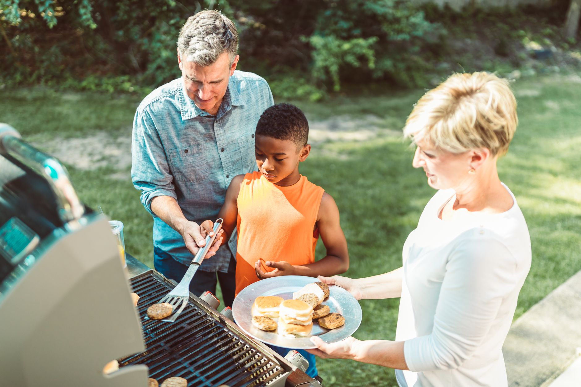 A family grilling in the backyard