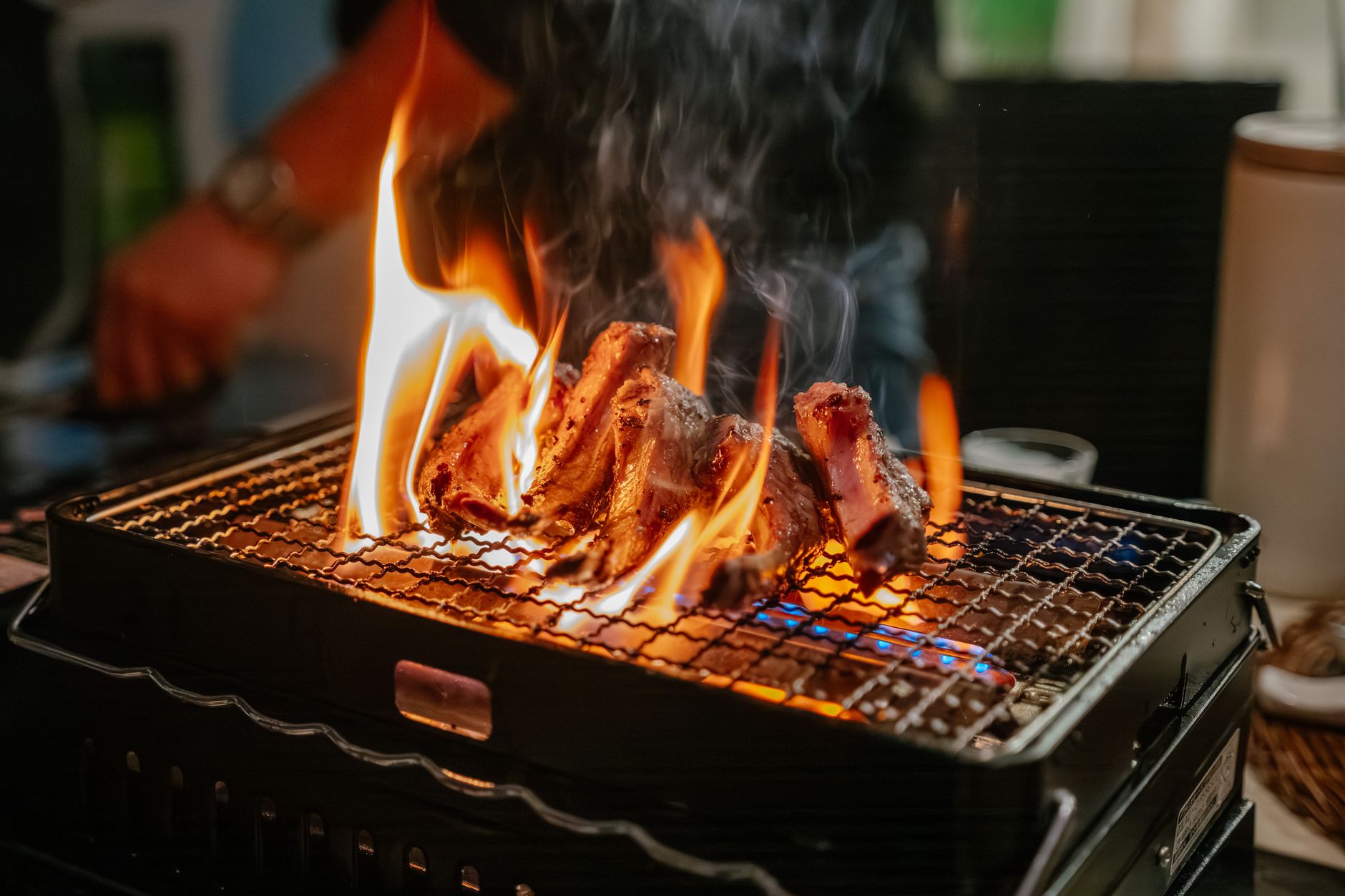 Flames rising from a grill