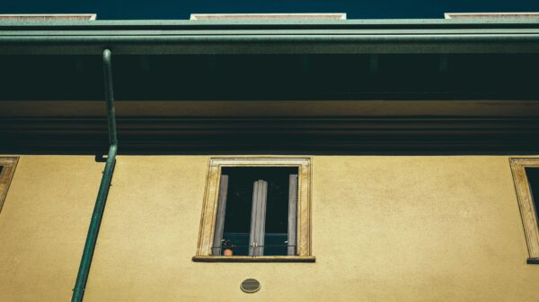 Best gutter cleaning tool: a gutter and downspout along a roofline