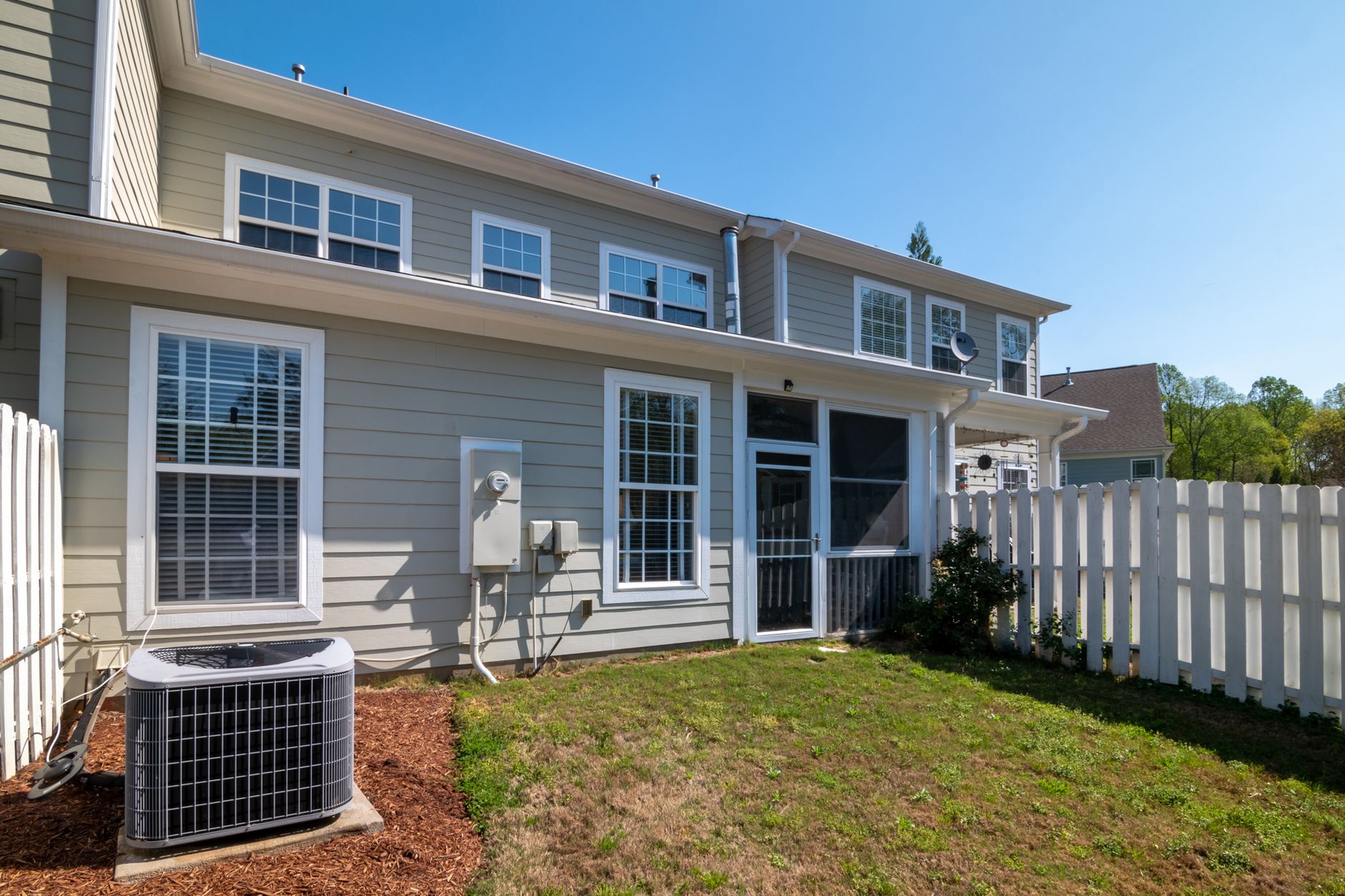 The back of a house with siding and an air conditioner