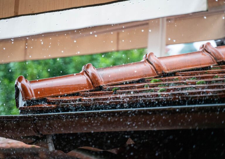 Best gutter guard: rain falling past a roof edge and gutter
