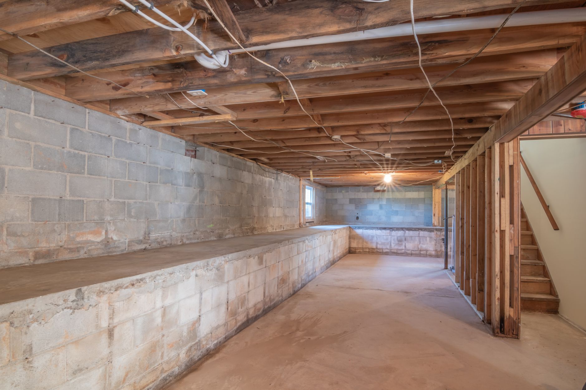 An unfinished basement with block walls
