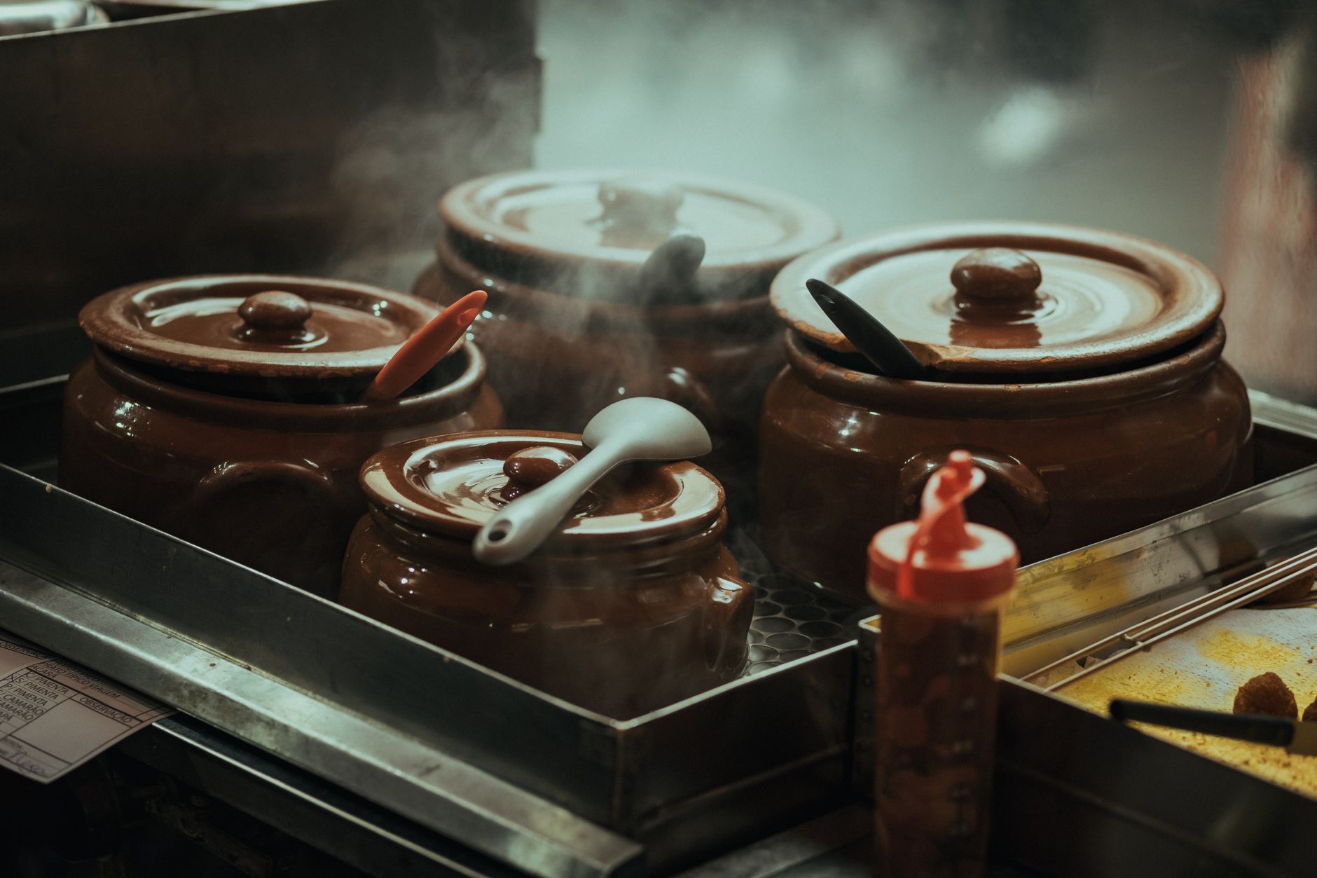 Clay pots cooking on a stovetop