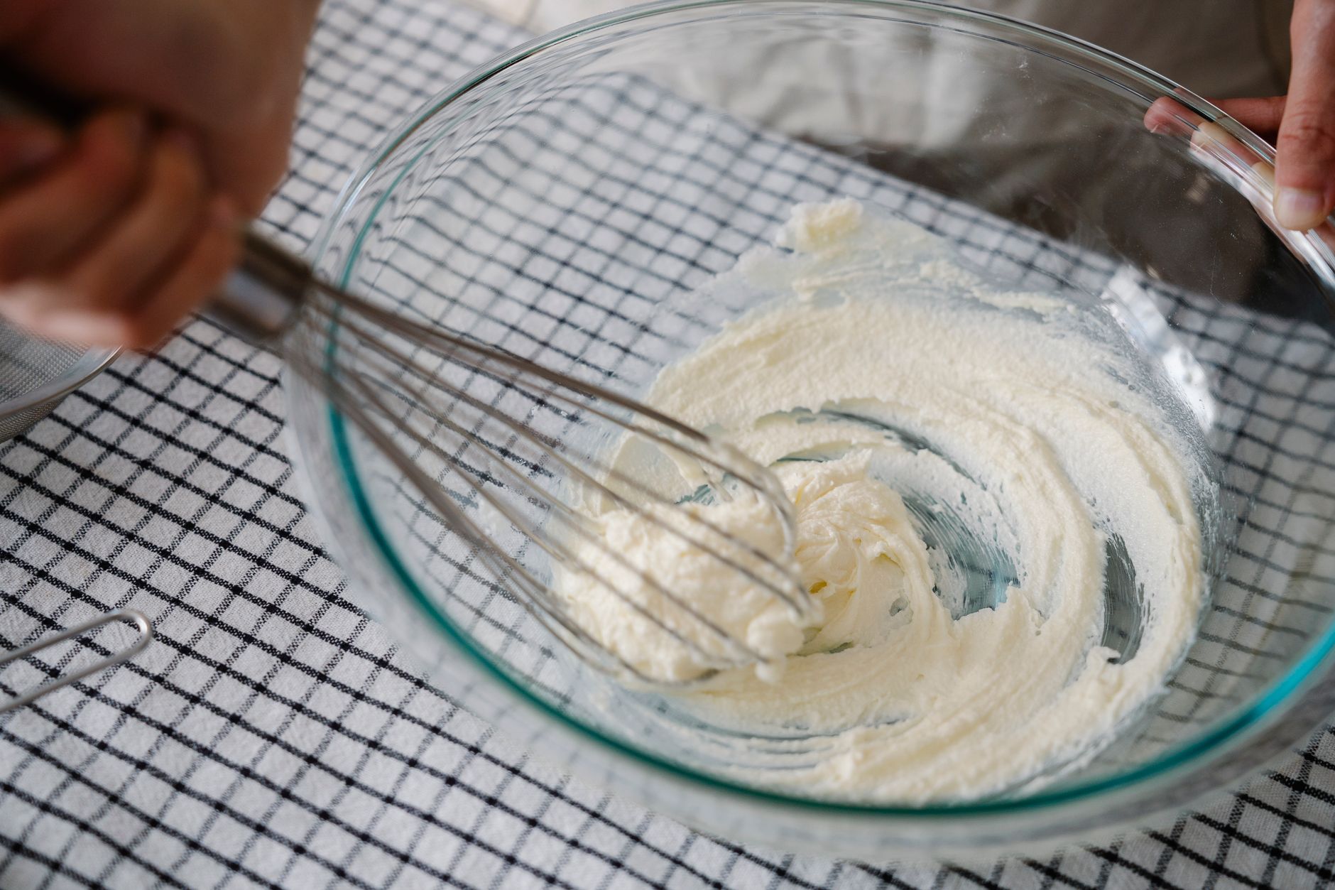 Cream being whisked in a bowl
