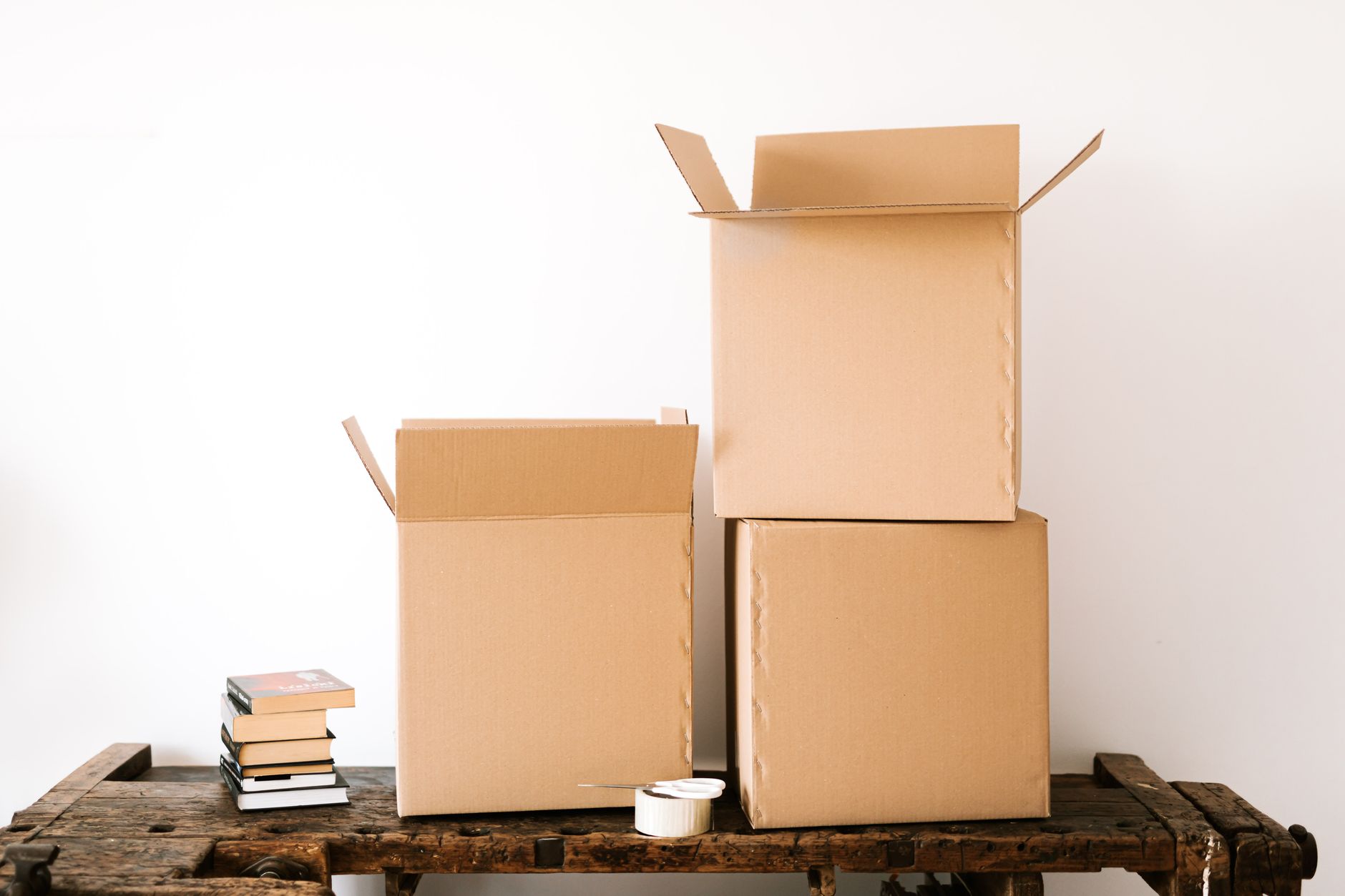 Cardboard boxes stacked on a wooden table