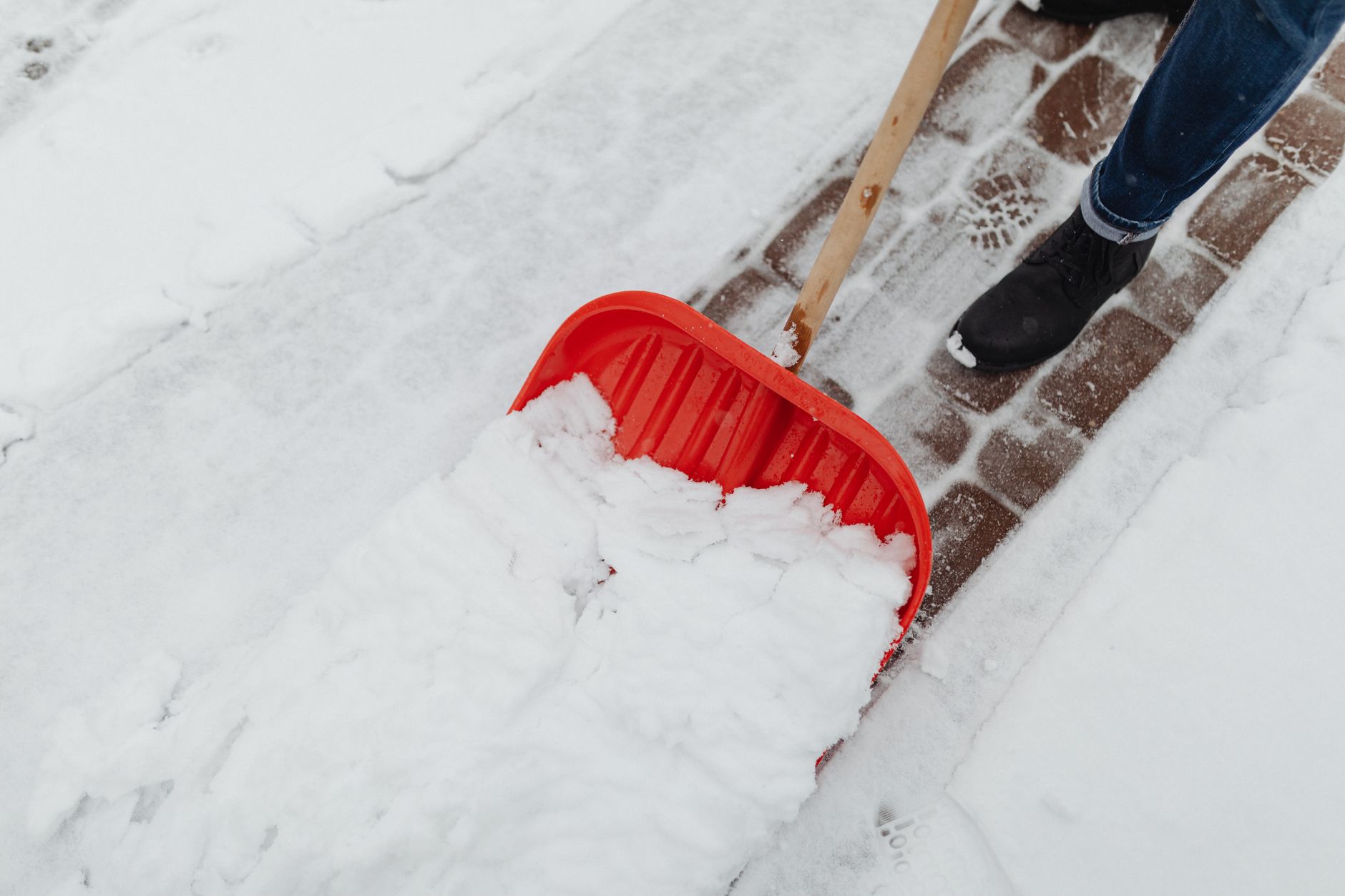 Someone clearing snow from a driveway