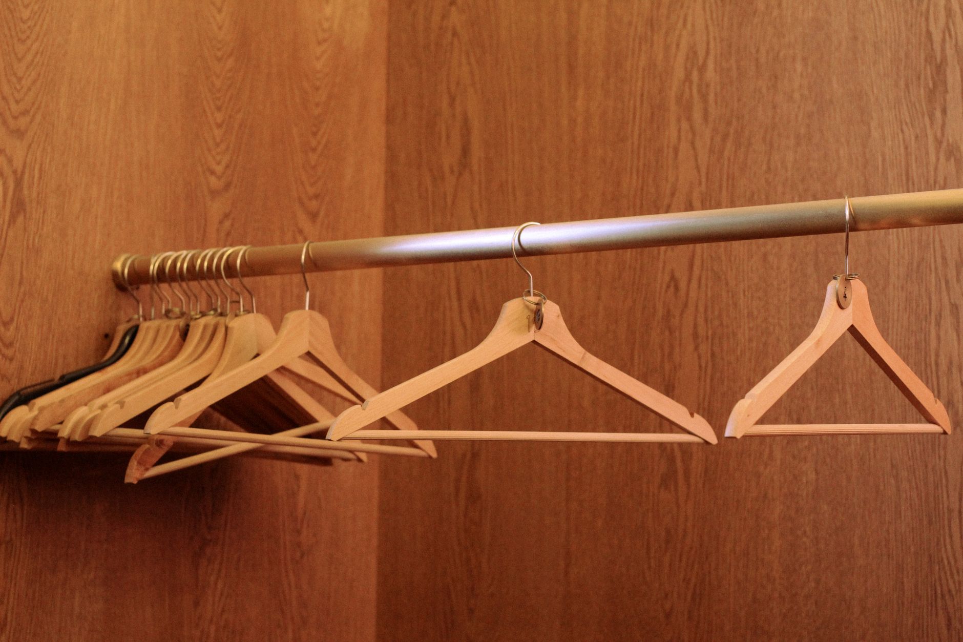 Wooden hangers on a closet rod