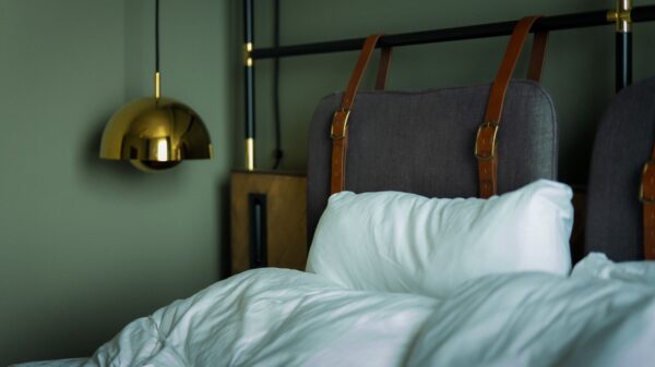 Best headboard: a made bed with an upholstered headboard in a bright bedroom