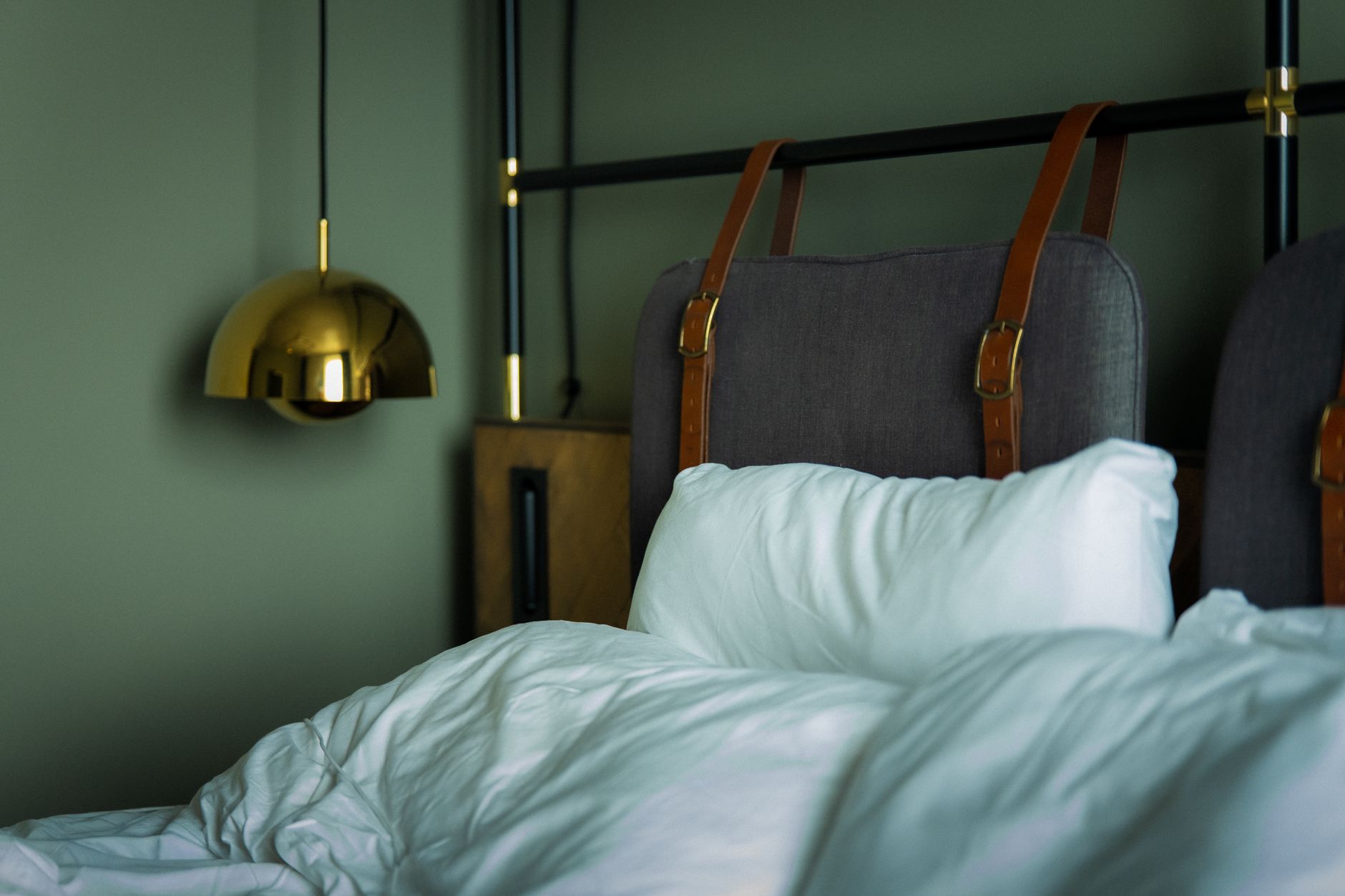 Best headboard: a made bed with an upholstered headboard in a bright bedroom