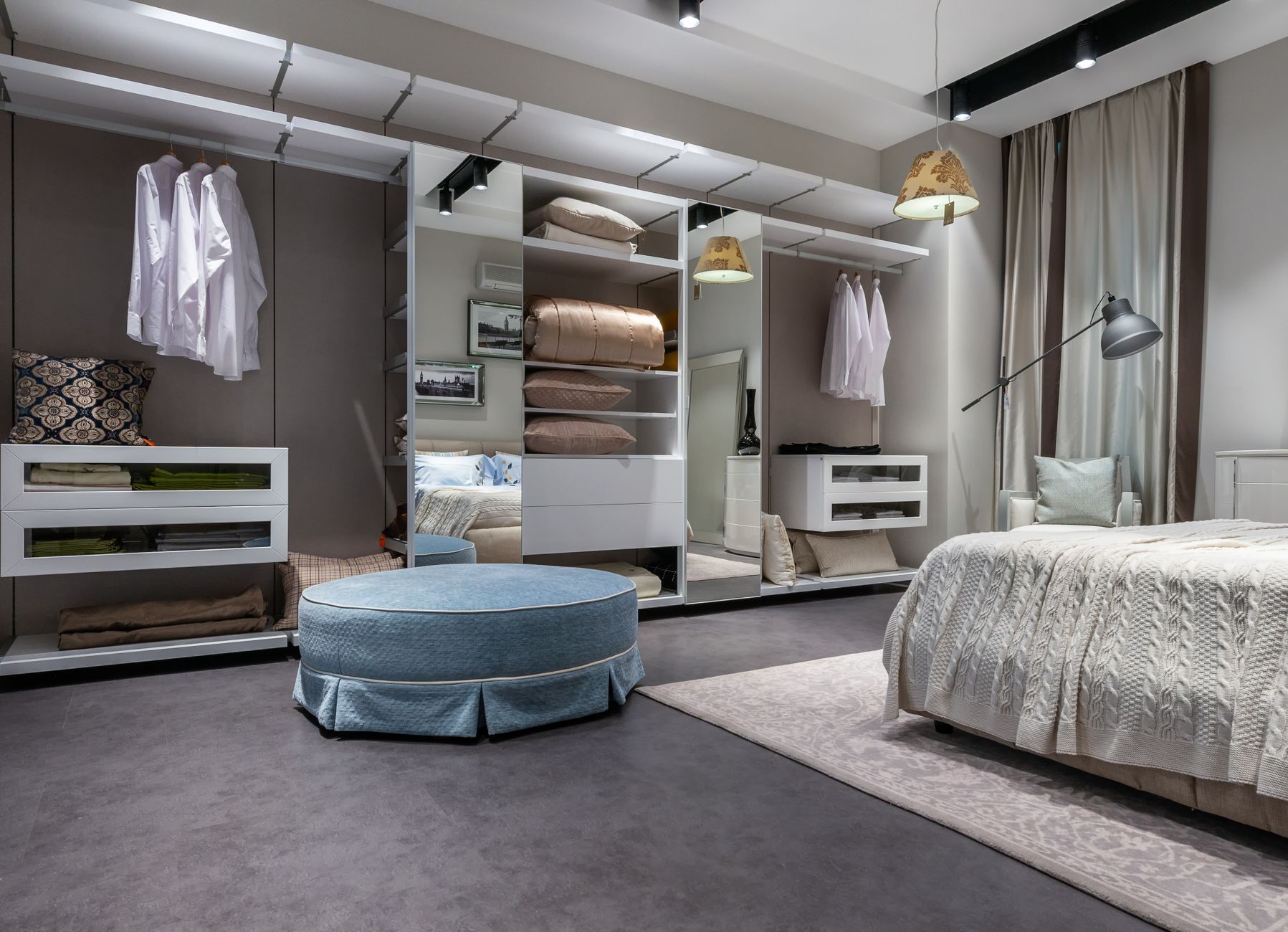 A modern bedroom with a bed against the wall