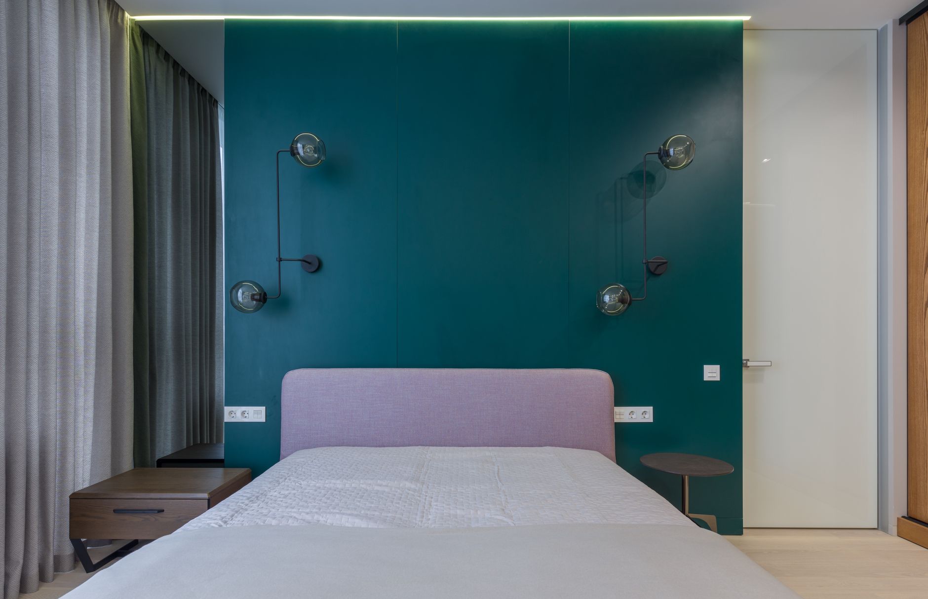 A softly lit bedroom wall above a bed