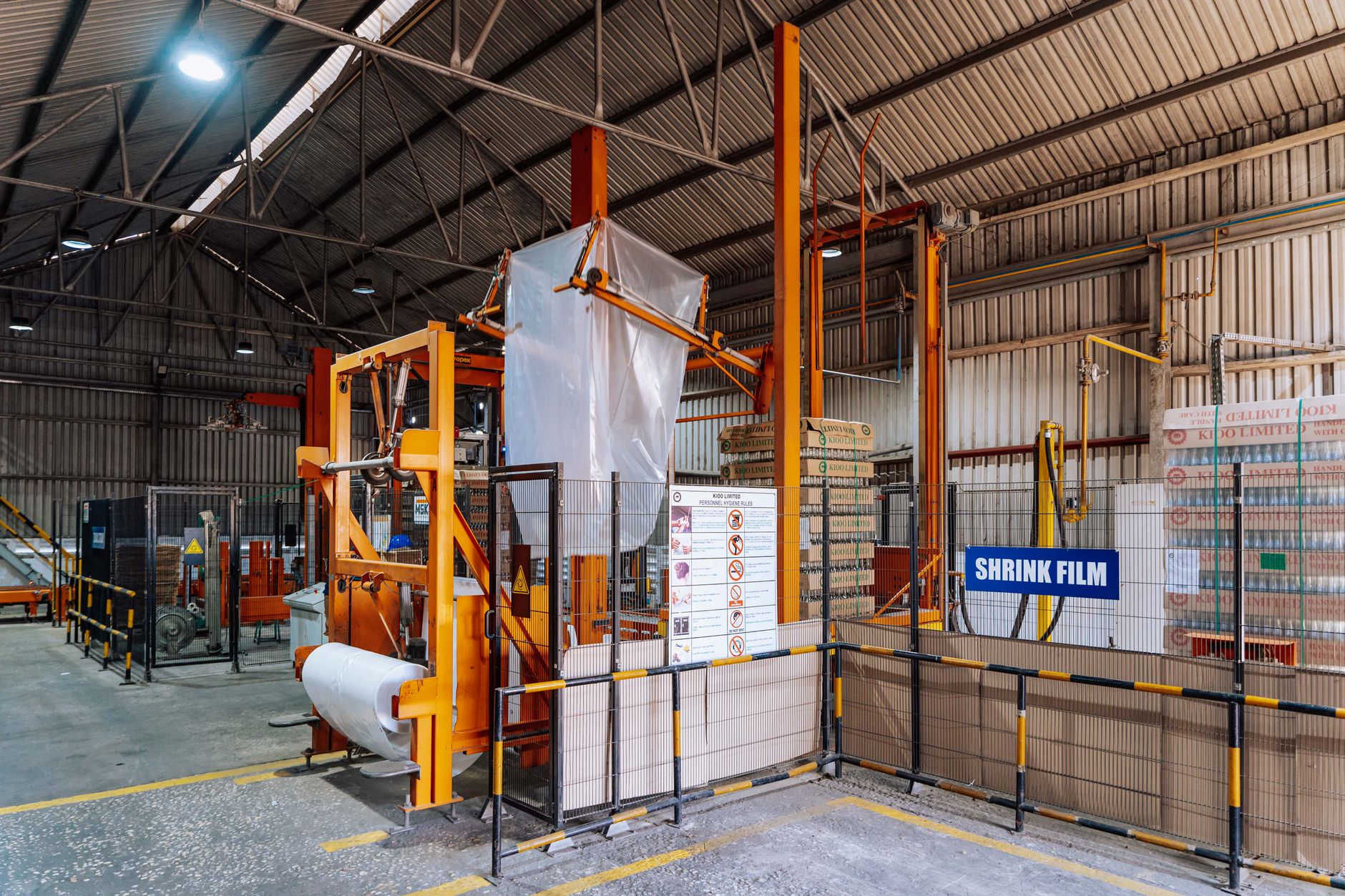 Shrink film packaging equipment in a warehouse