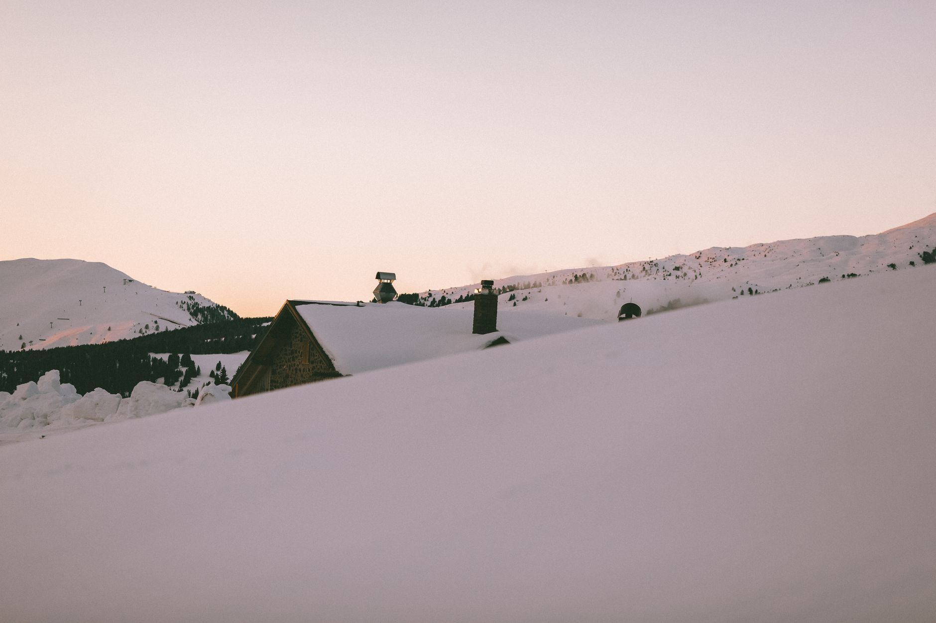 Snow-covered rooftops at dusk