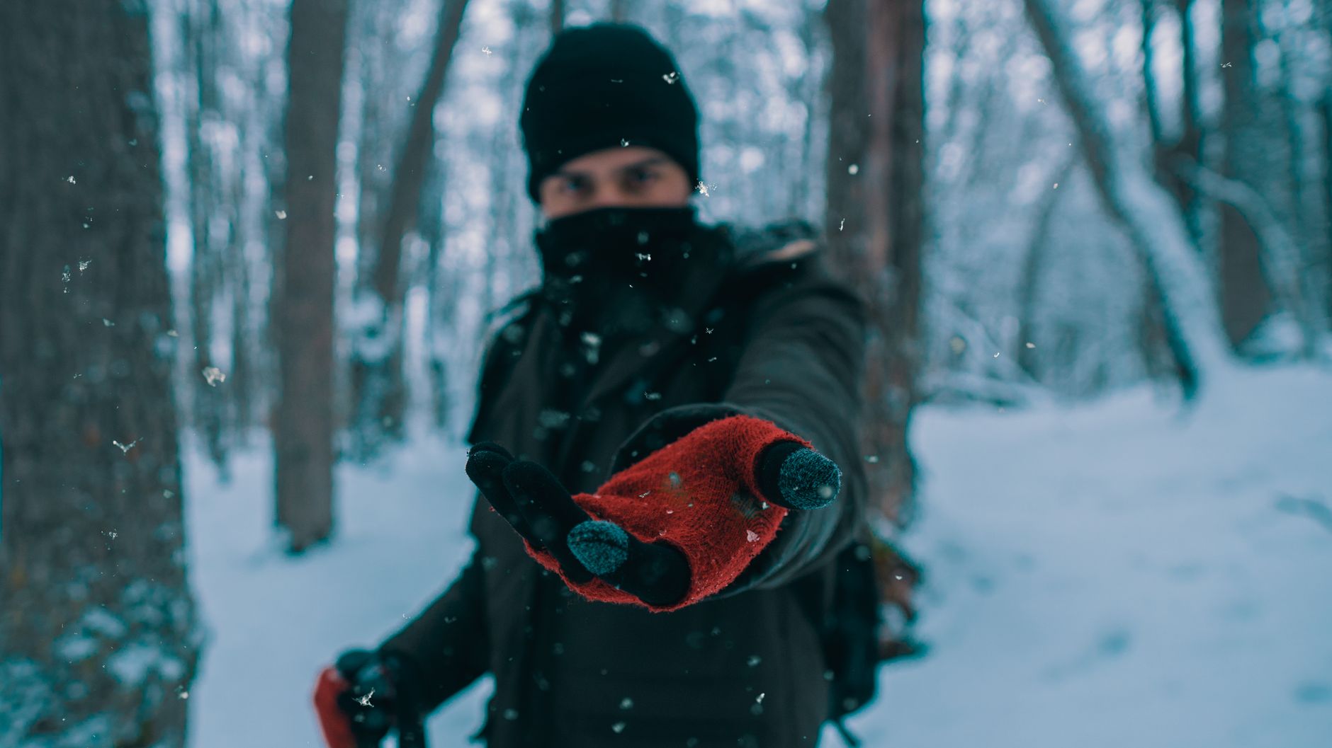 Best heated gloves guide: gloved hands outdoors on a snowy day