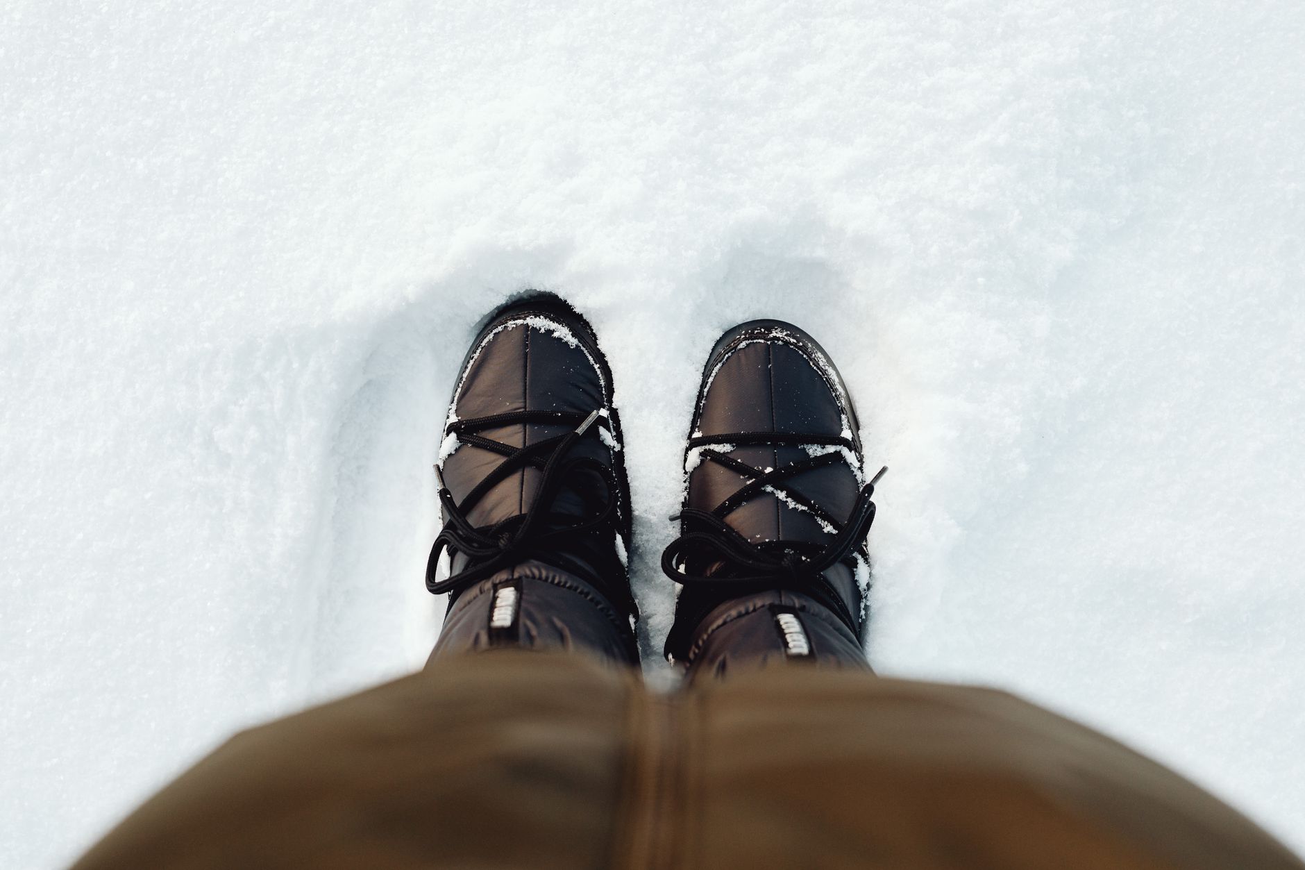 Winter boots standing in fresh snow