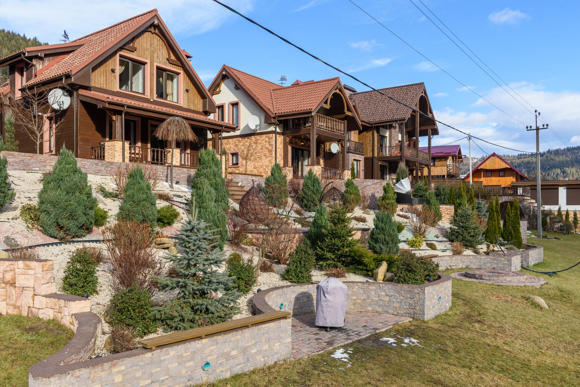 Wooden houses with landscaped shrubs on a hillside