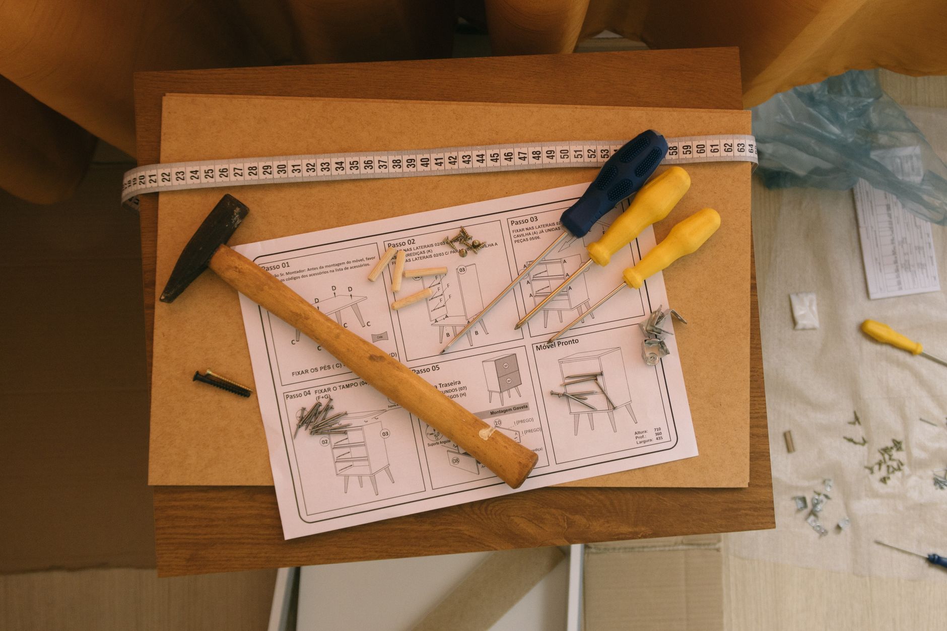 Best allen wrench set: a person assembling furniture at home with hand tools