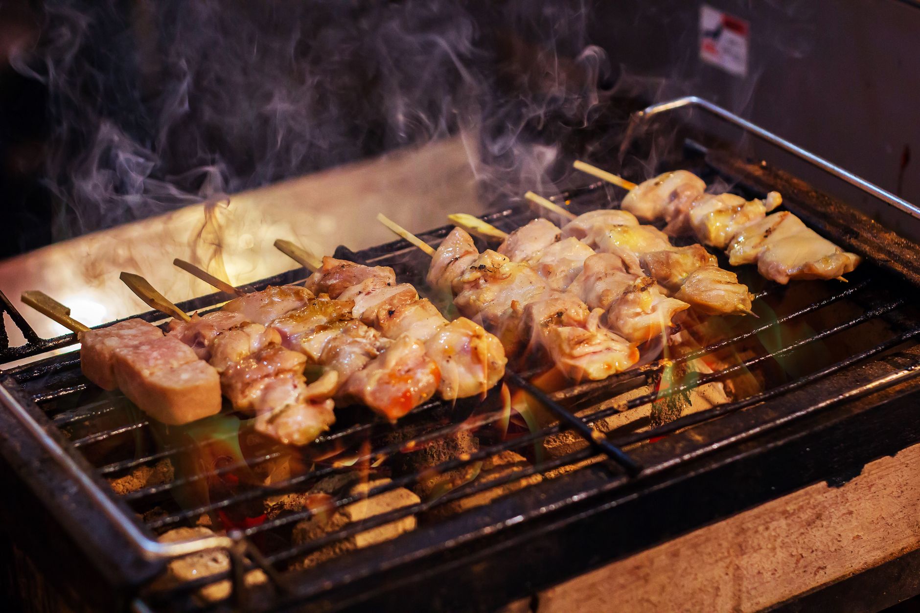 Skewers grilling on a charcoal grill