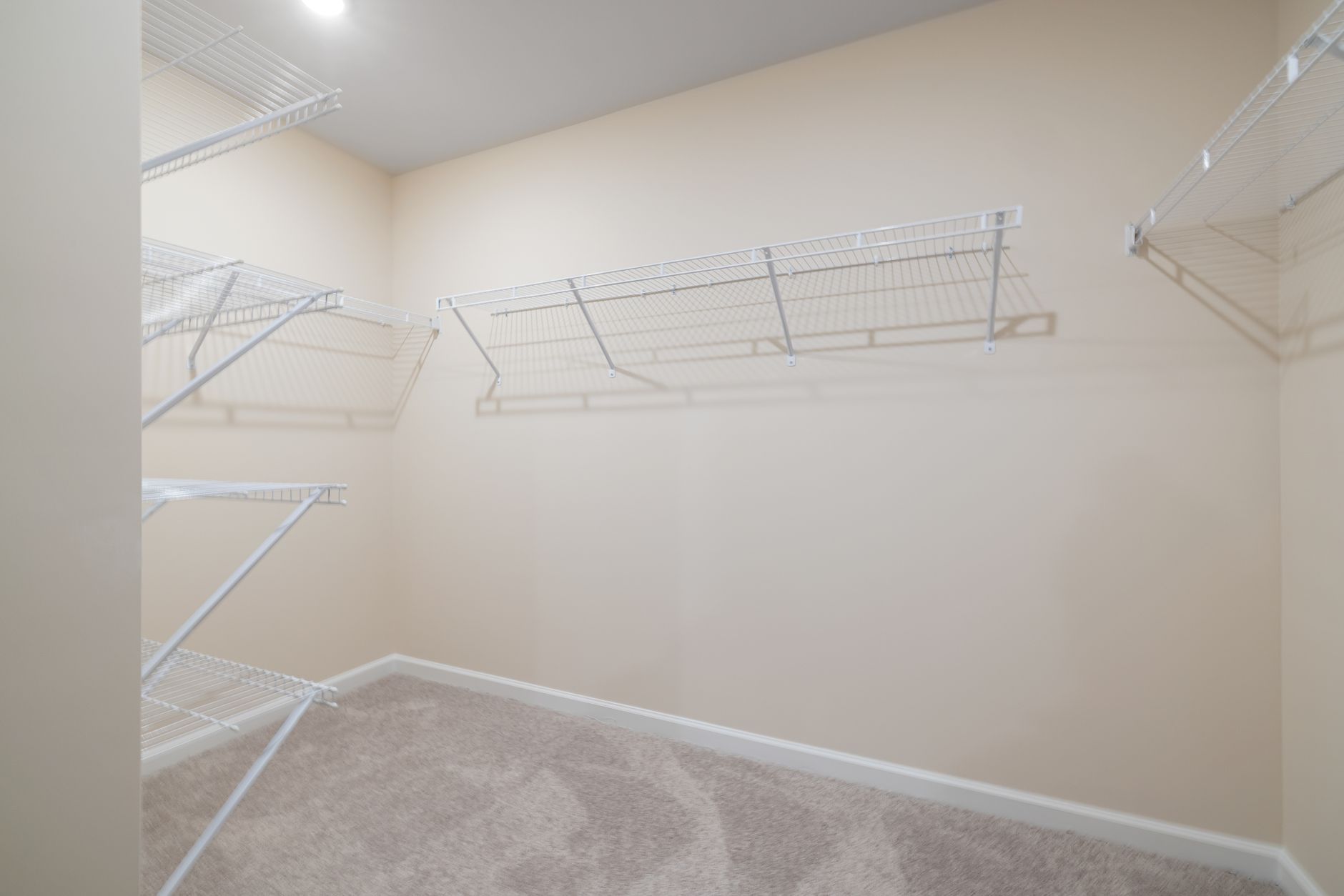 An empty closet with wire shelves