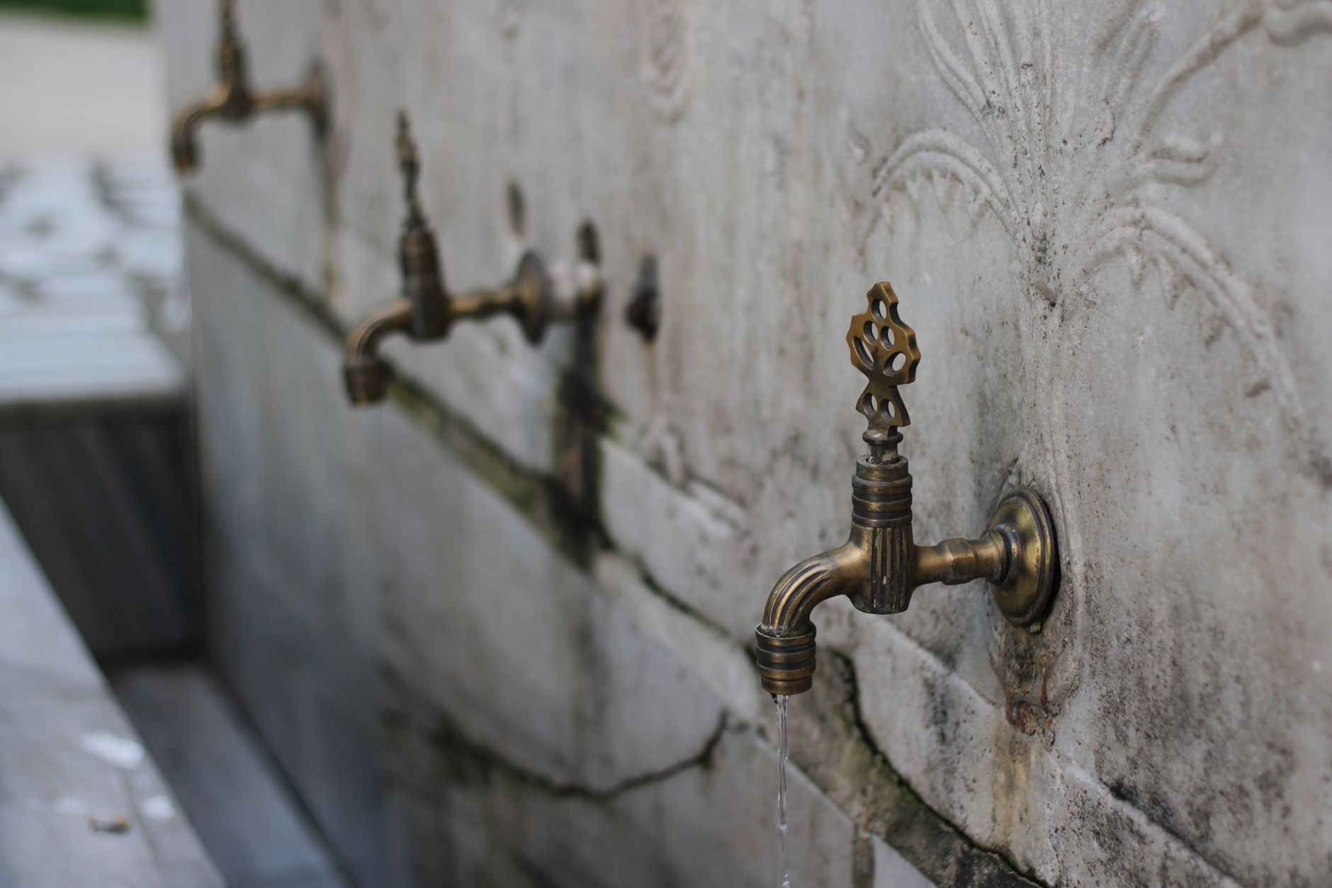 Brass spigots on a stone wall