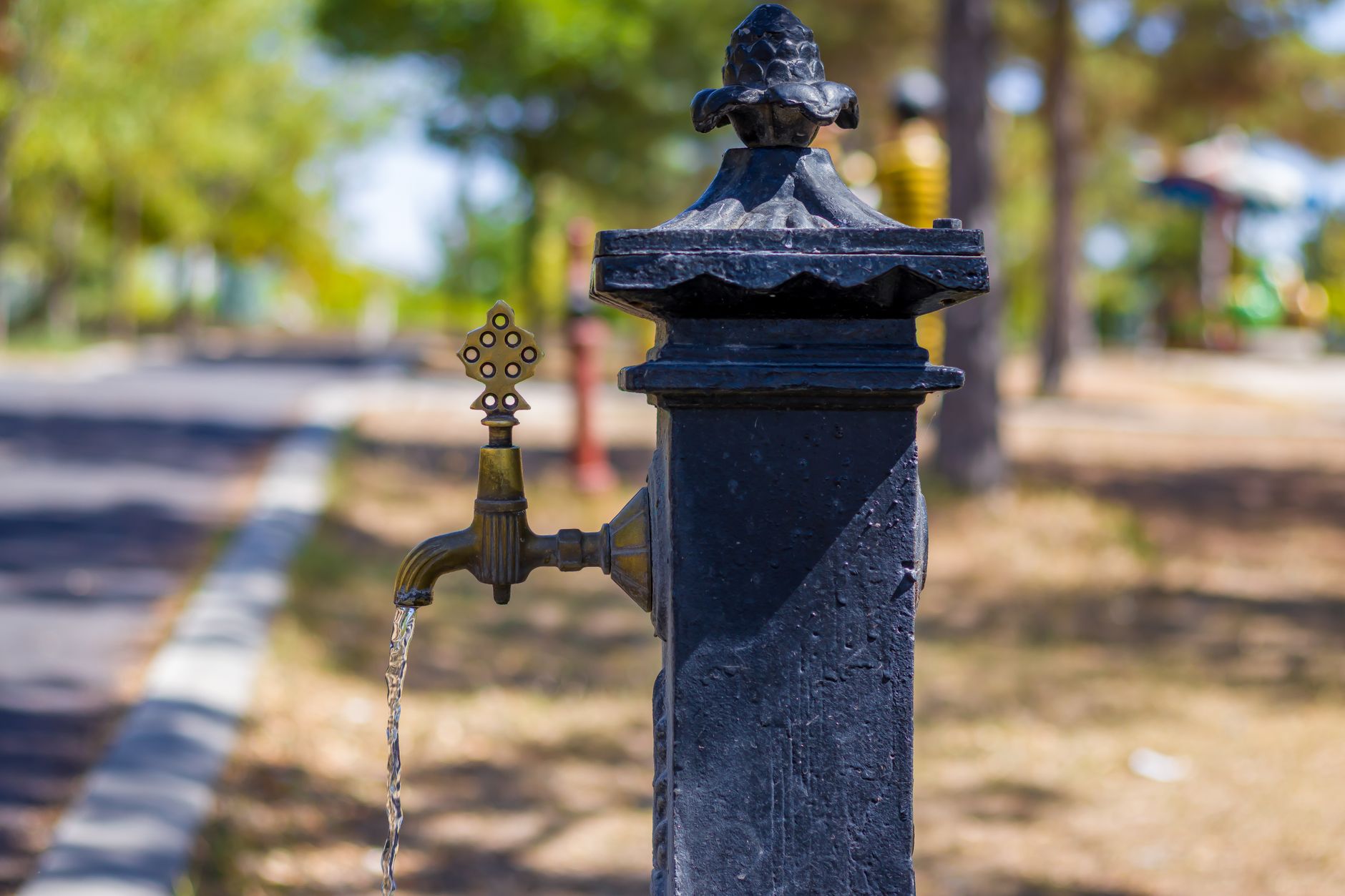 An outdoor water faucet on a house wall