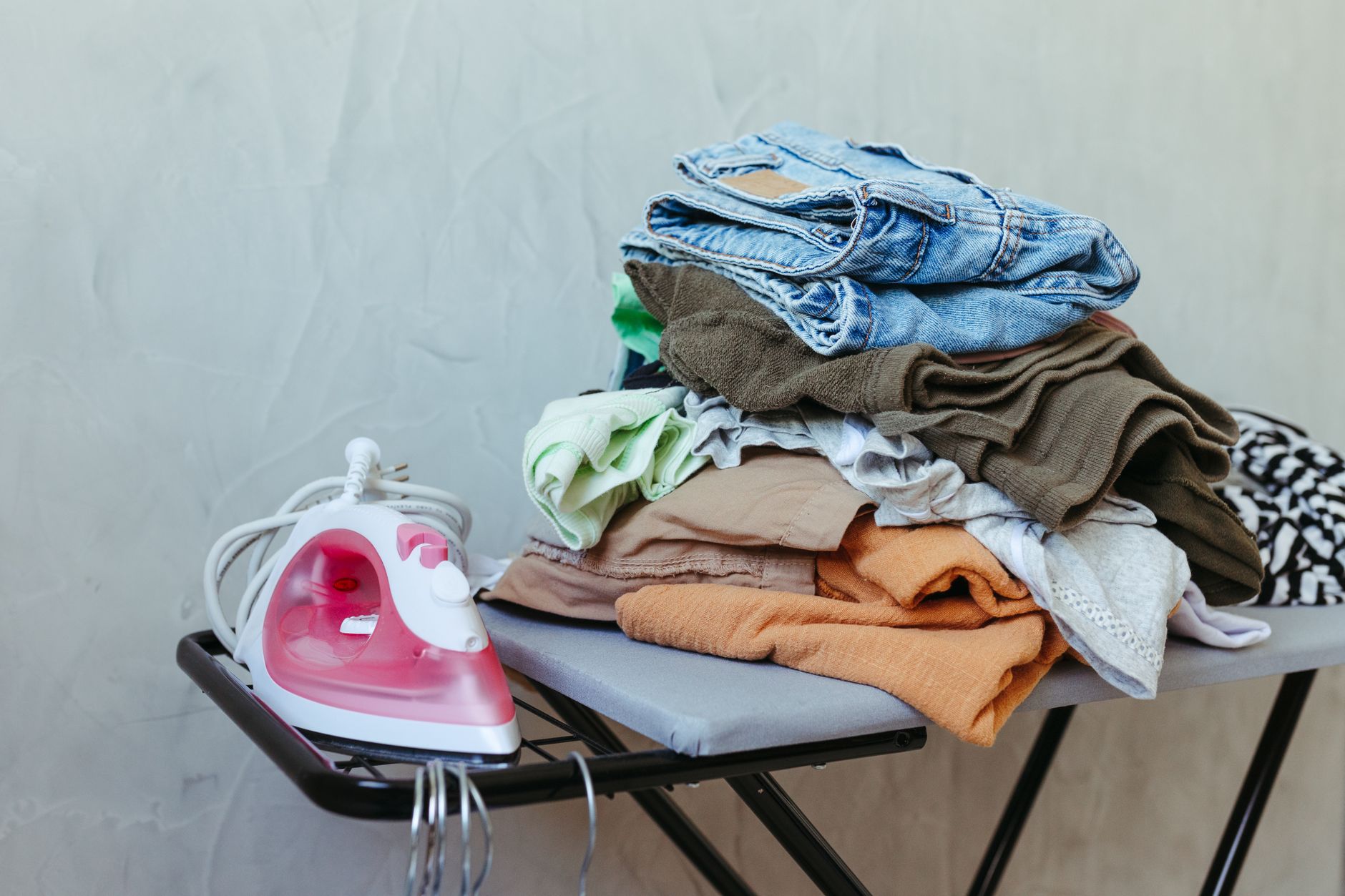 Best ironing board: an iron and a pile of clothes on a board