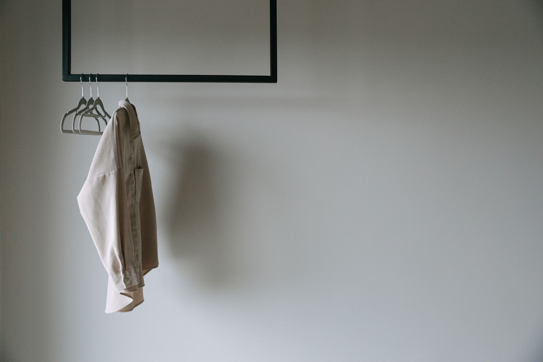A shirt on a hanger on a wall rail