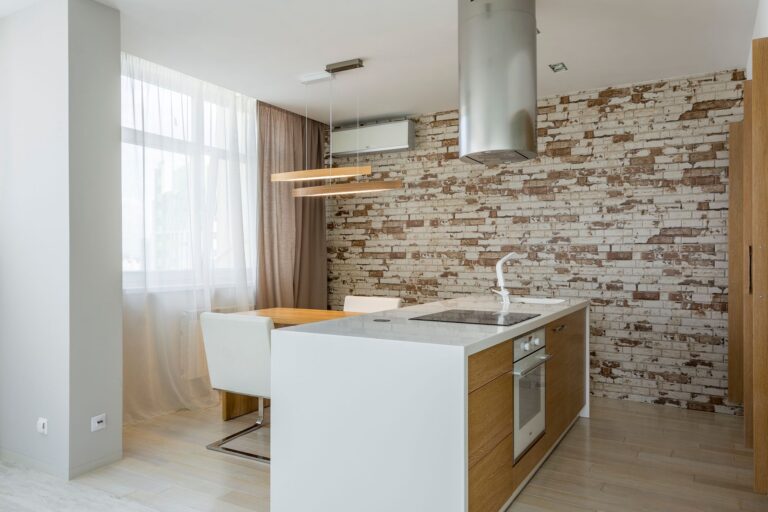 Best island range hood: a chimney hood over a white kitchen island