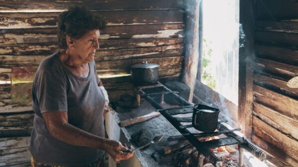 Best jar opener: an older woman cooking on a wood stove