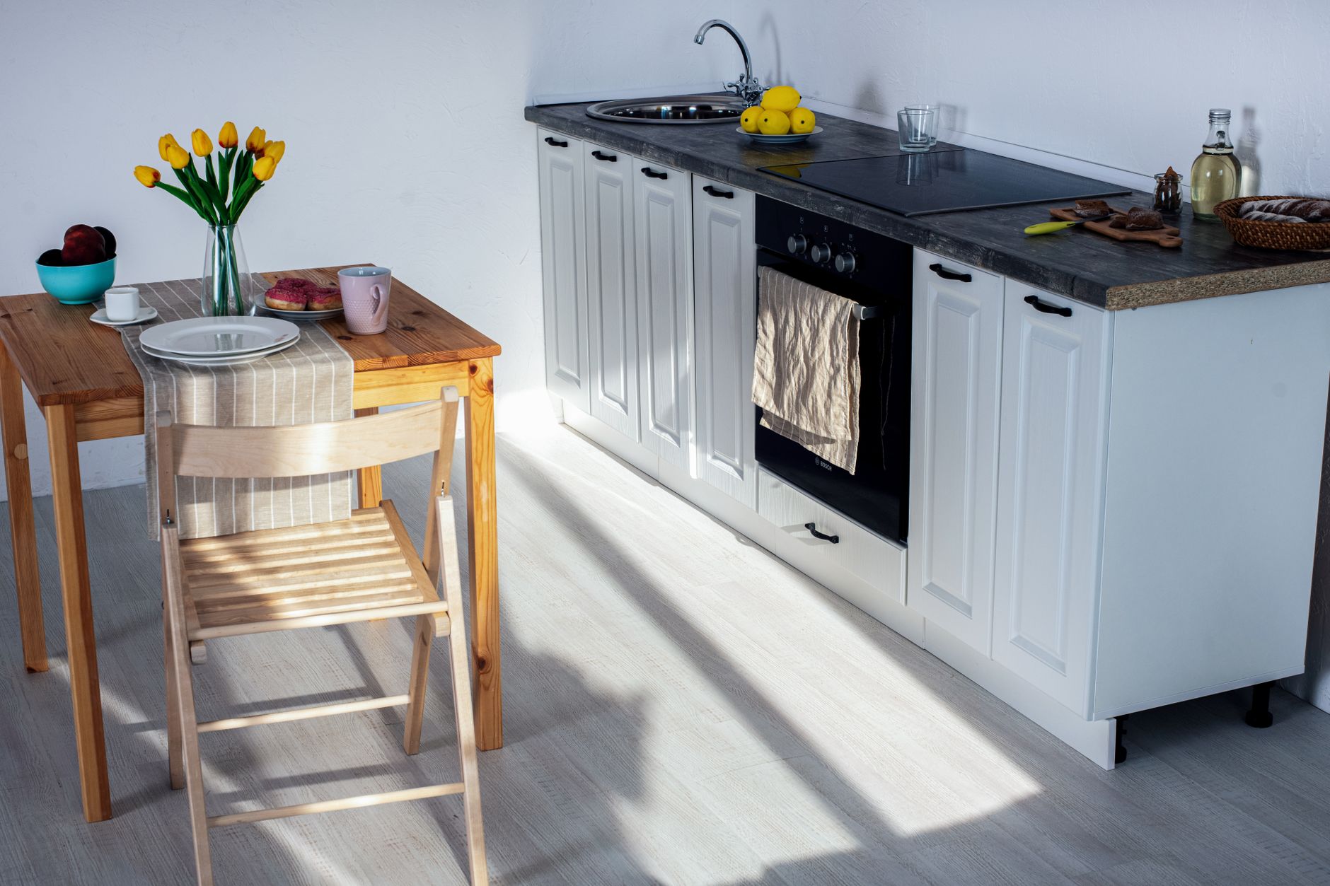 A small bright kitchen with a dining table