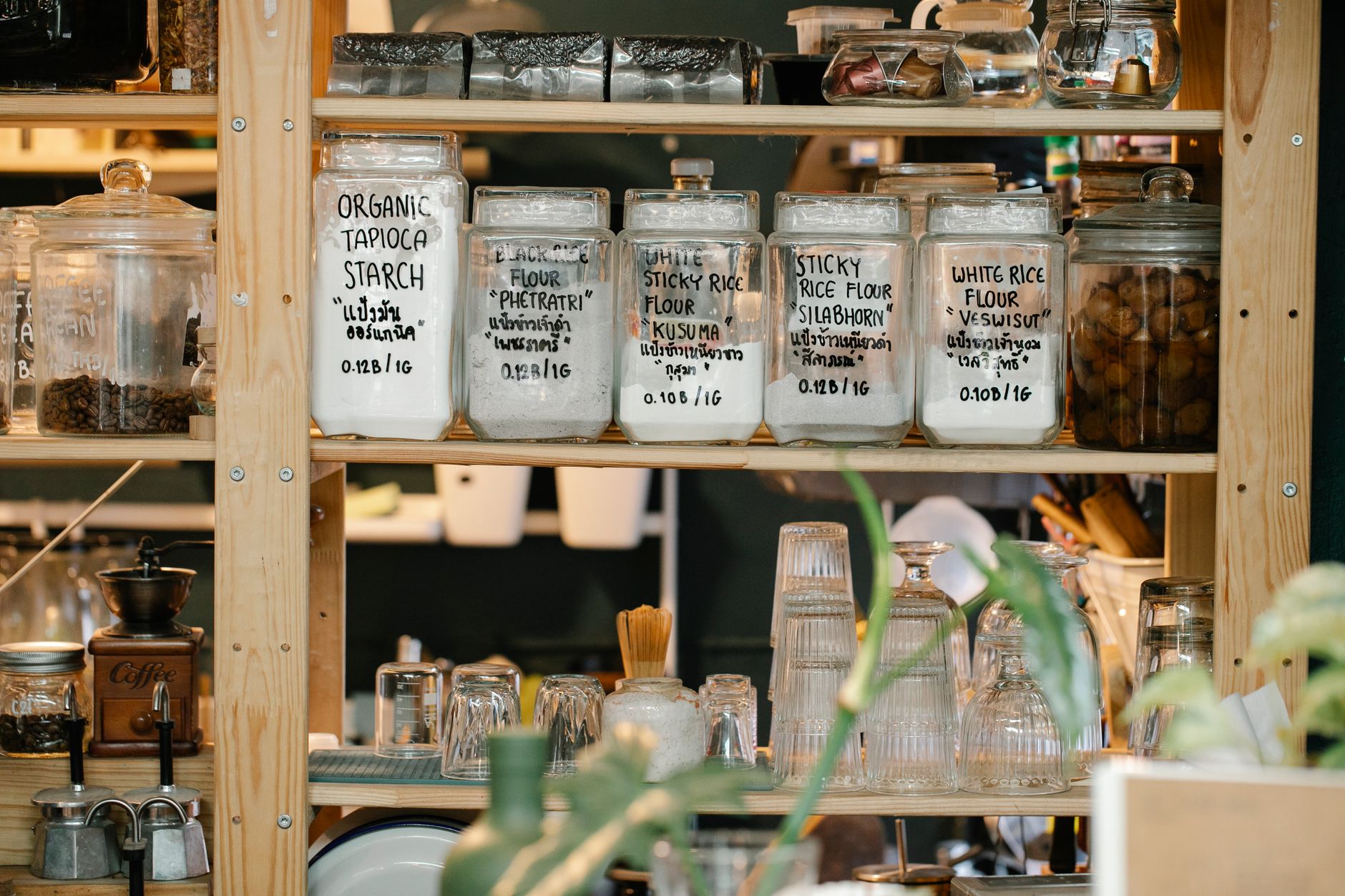Labeled jars of flours and grains on shelves