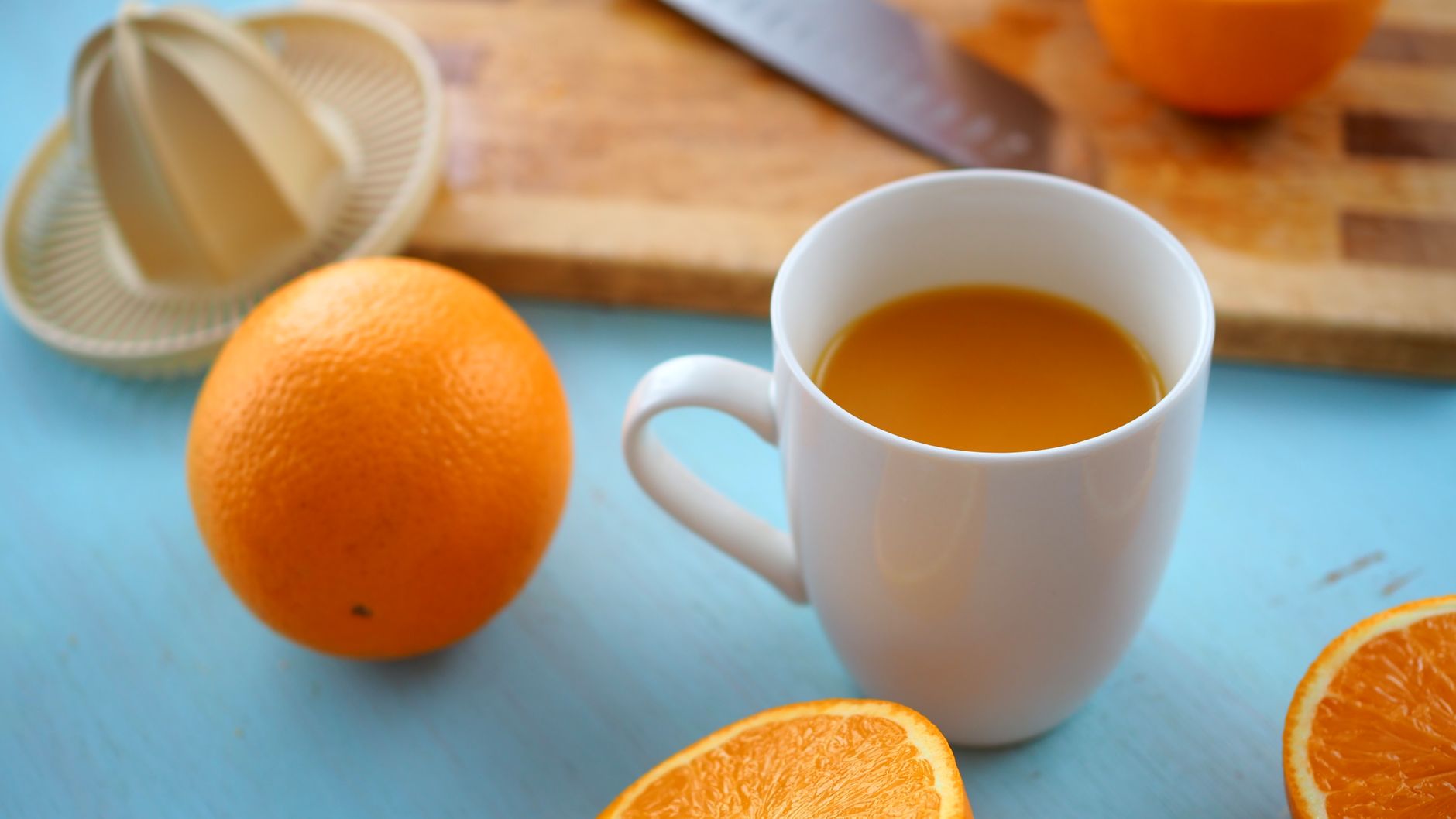 Oranges and a cup of orange juice