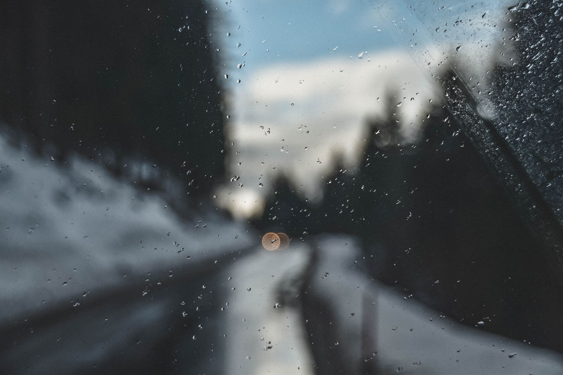Snow covering a parked car on a winter morning