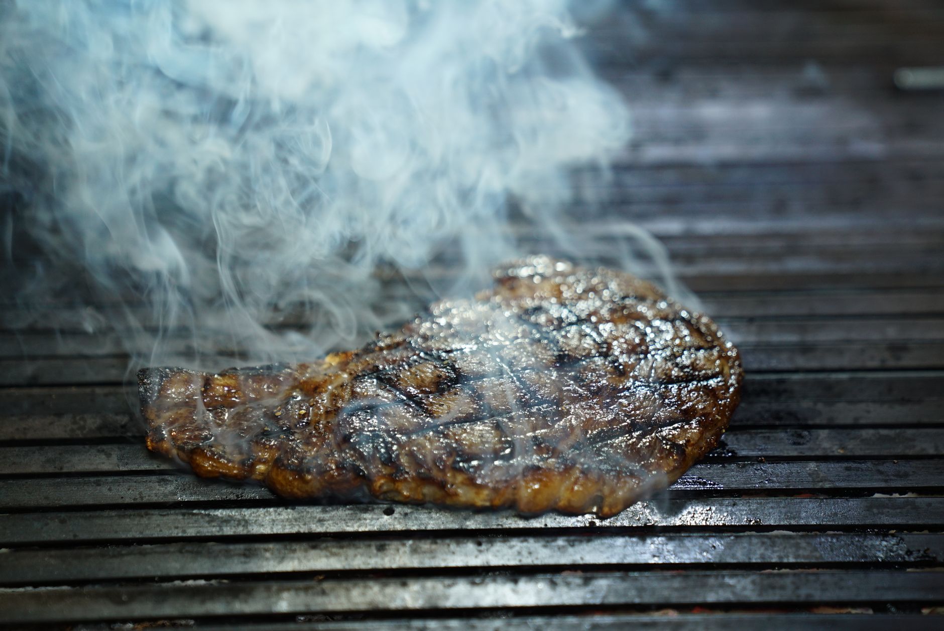 Steak searing on a grill grate