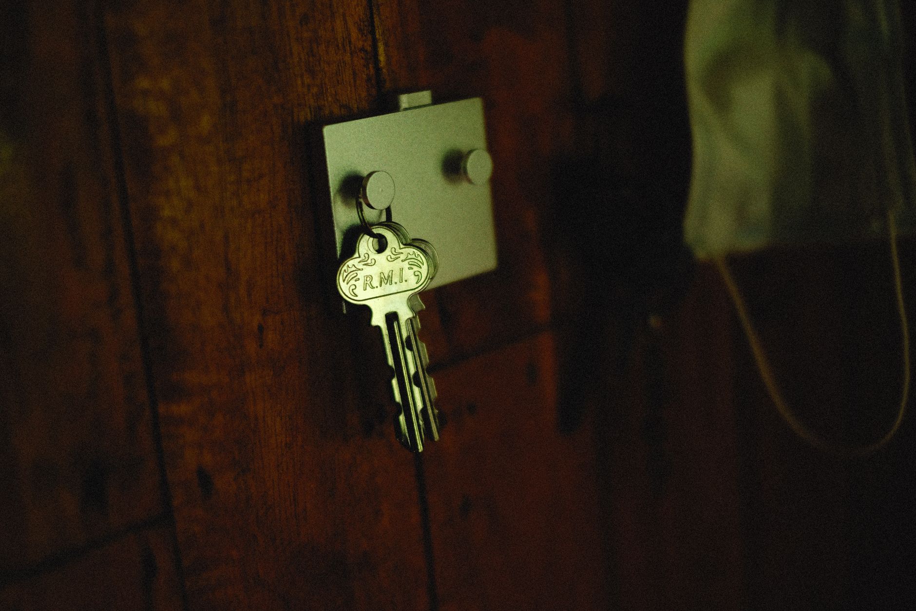 Best key holder: house keys hanging on a wall hook by a door
