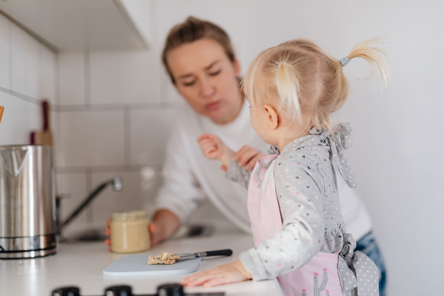 A young child helping in a home kitchen