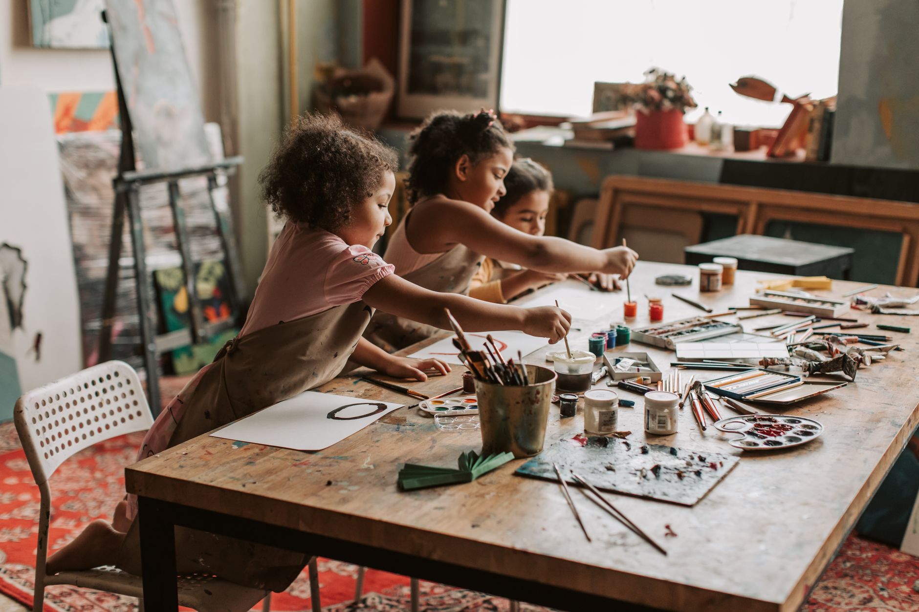 Paints and brushes on a table for a craft project