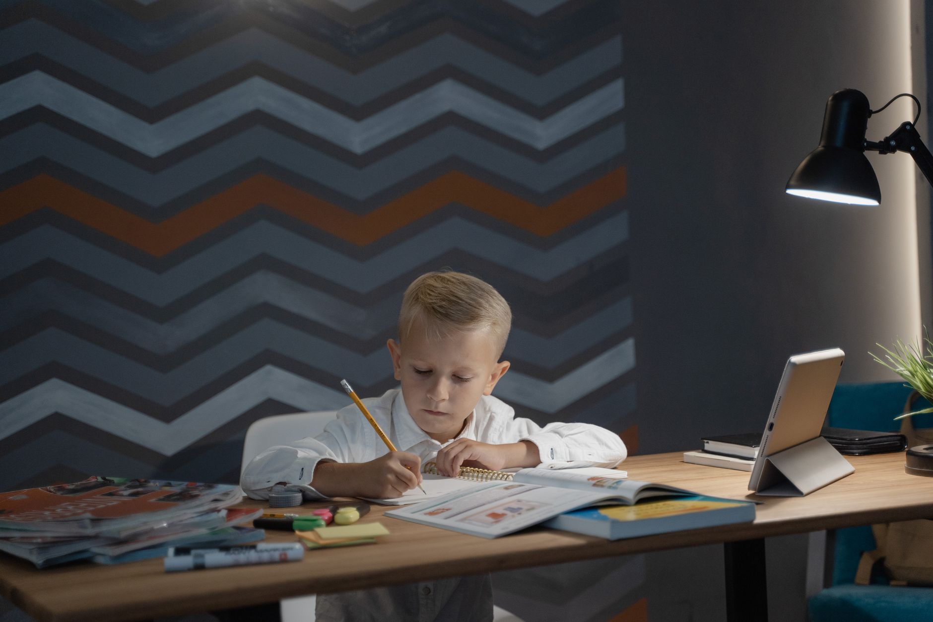 Pencils and a notebook on a small desk