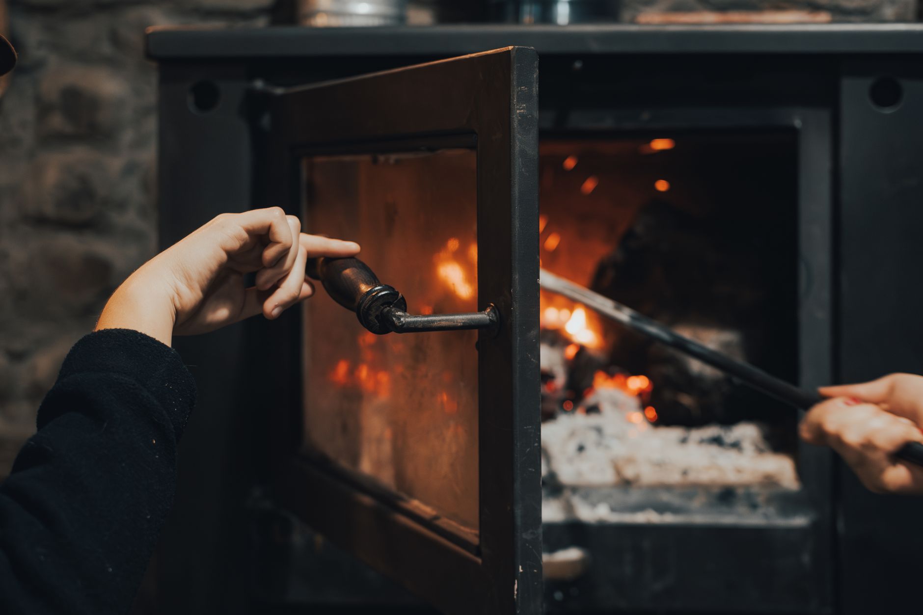 A fire burning inside a wood stove