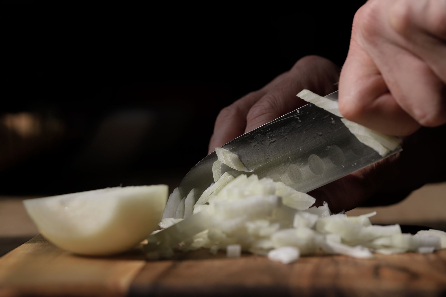 Chopping an onion with a chef knife